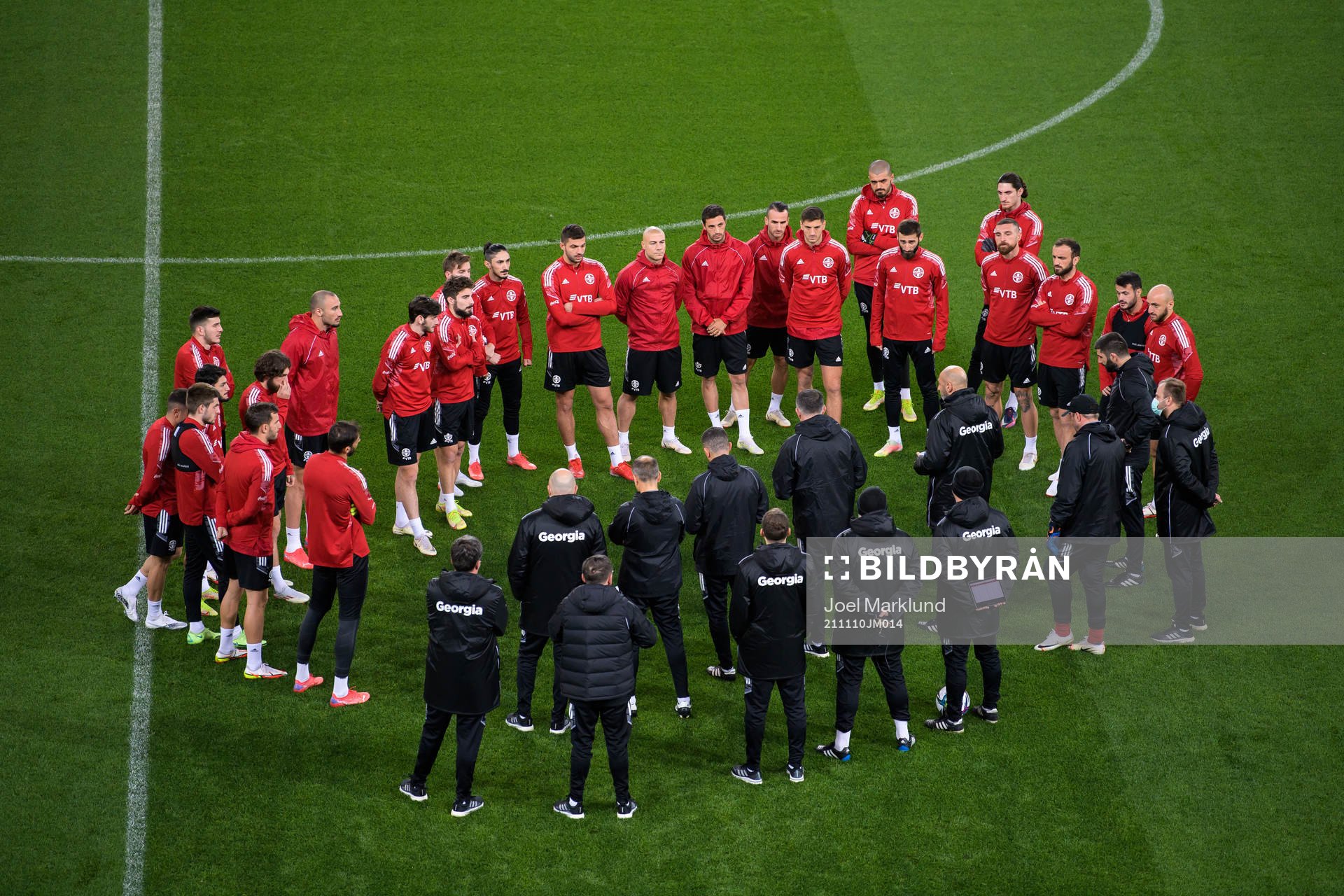 Players listen to head coach Willy Sagnol of the Georgian