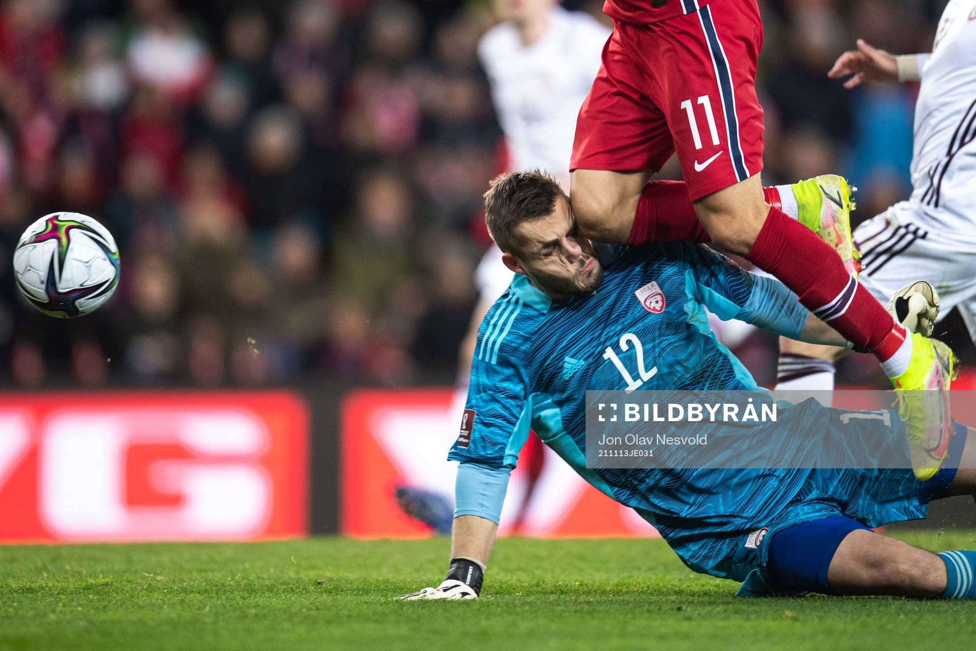 Mohamed Elyounoussi of Norway hits goalkeeper Roberts Ozols