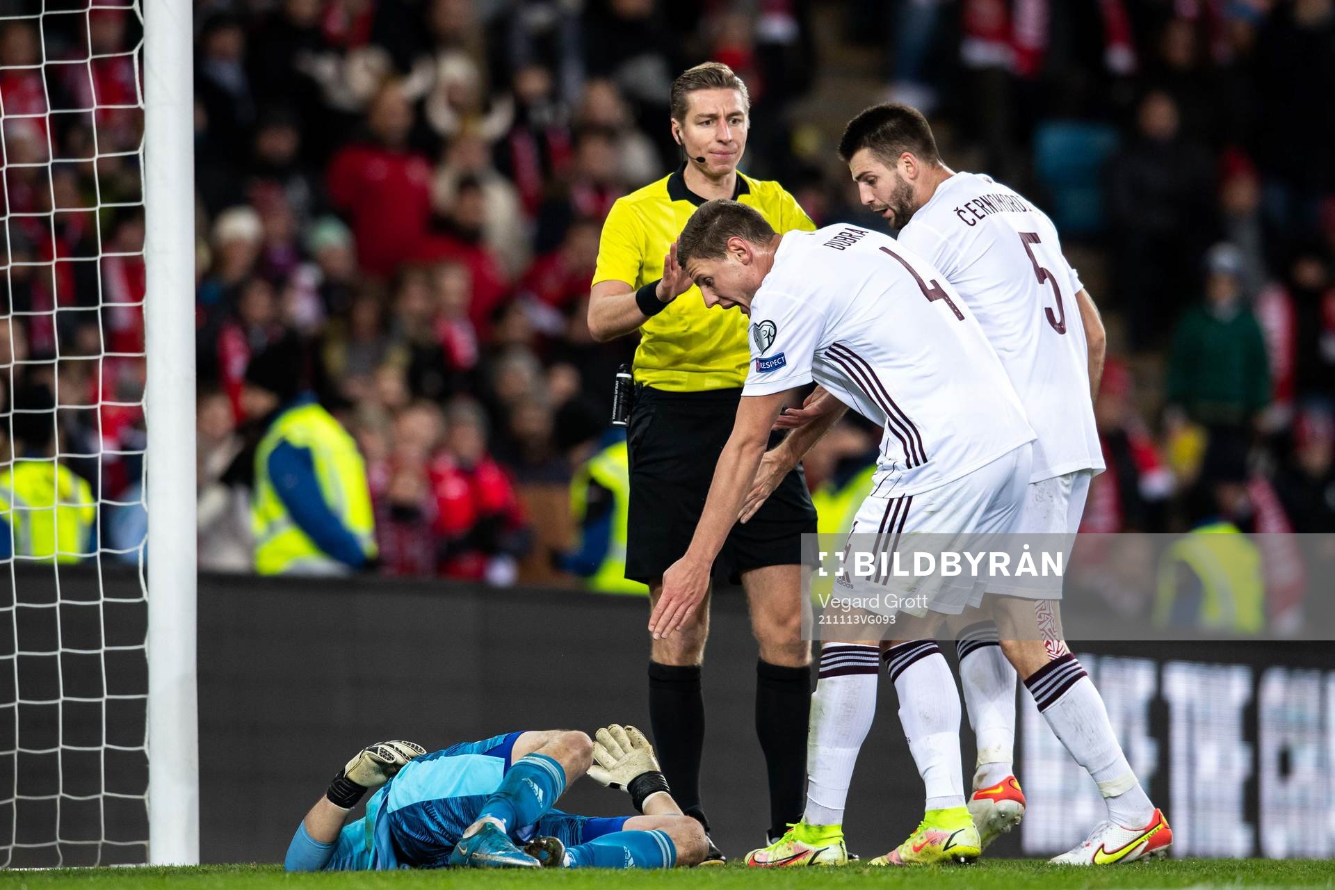 Goalkeeper Roberts Ozols of Latvia in pain