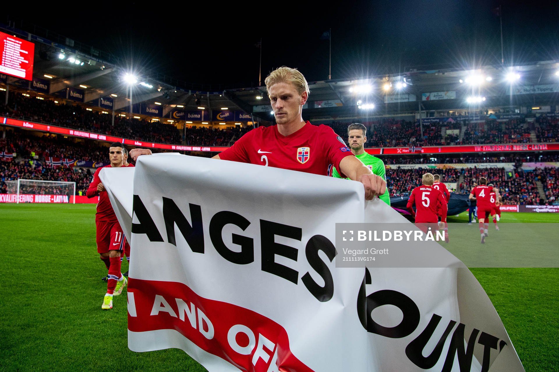 Morten Thorsby of Norway holds a banner with the text Make