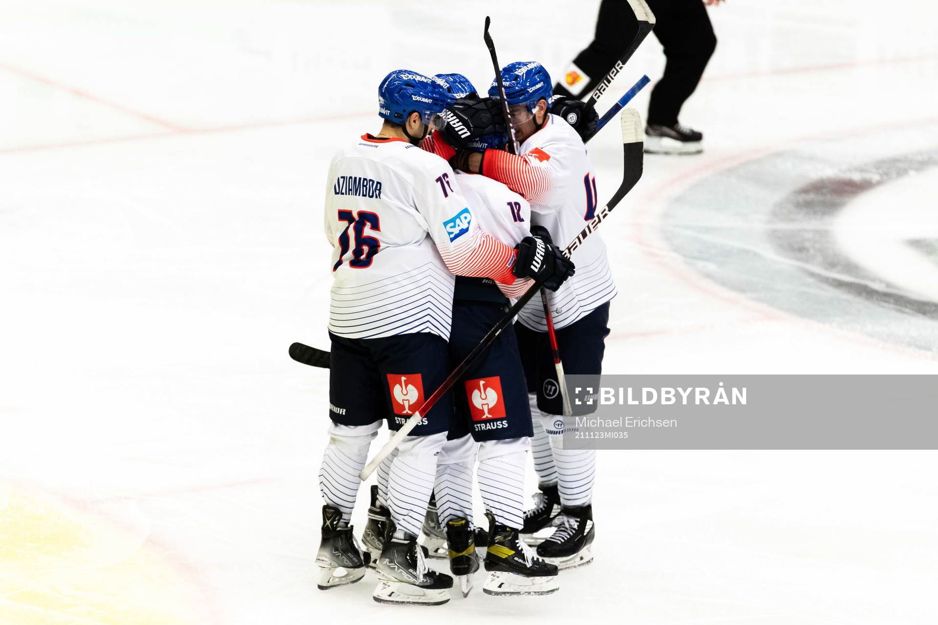 Luca Tosto of Adler Mannheim celebrate with teammates