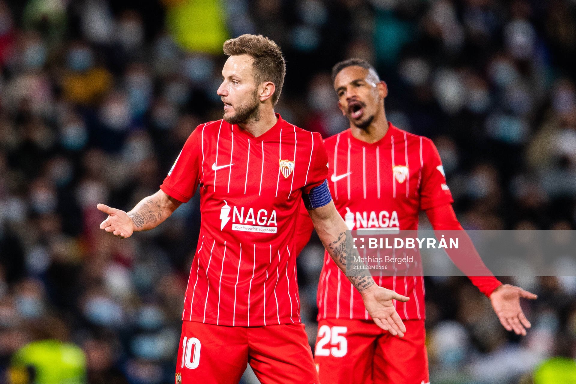 Ivan Rakitic and Fernando of Sevilla react