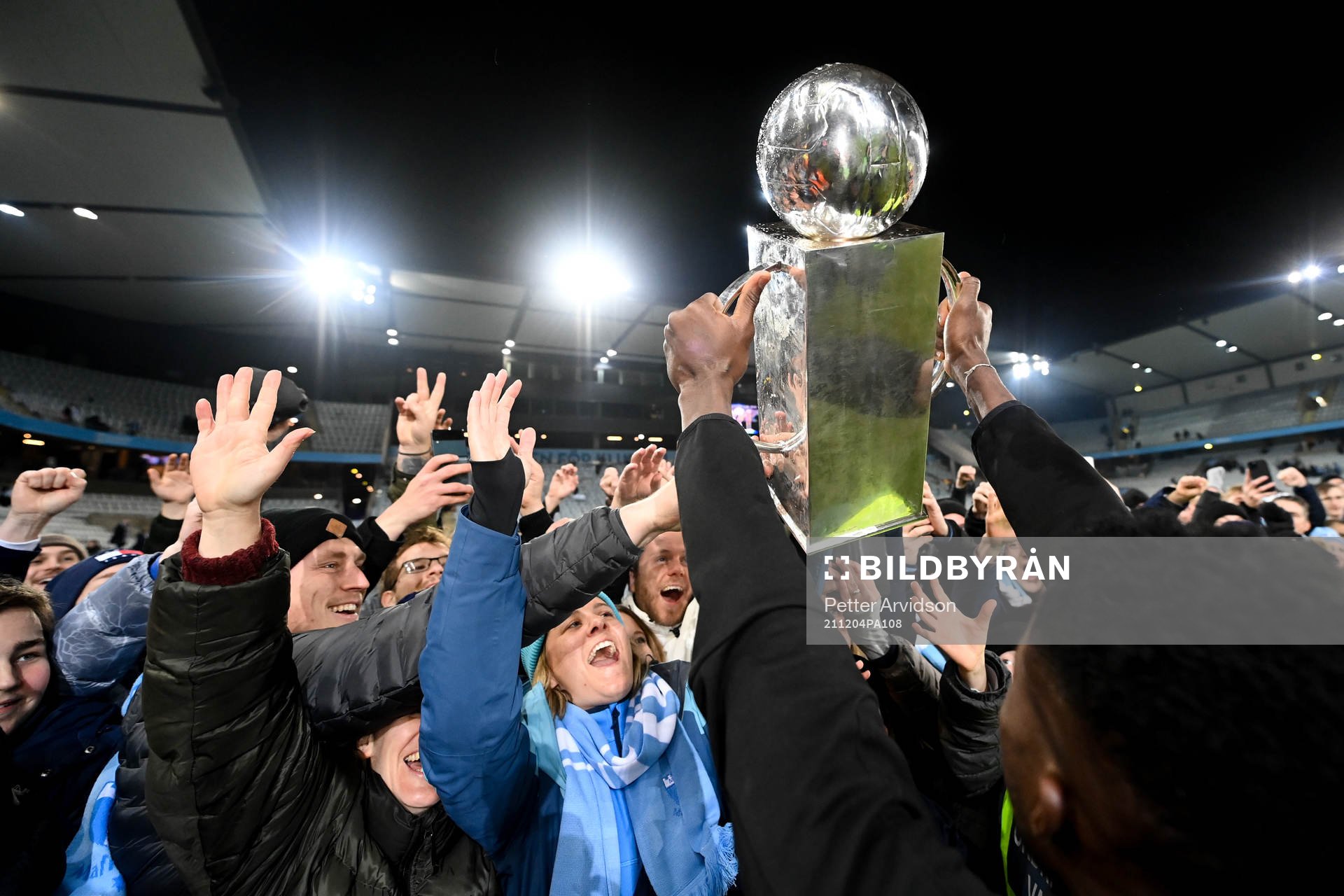 Malik Abubakari håller upp Lennart Johanssons pokal mot