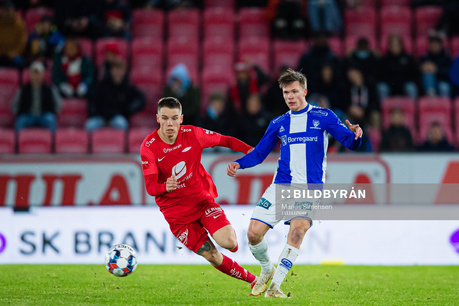 Robert Thomas Taylor of Brann and Eirik Wichne of Sarpsborg 08 during the Eliteserien match between Brann and Sarpsborg 08 on December 12, 2021 in Bergen.