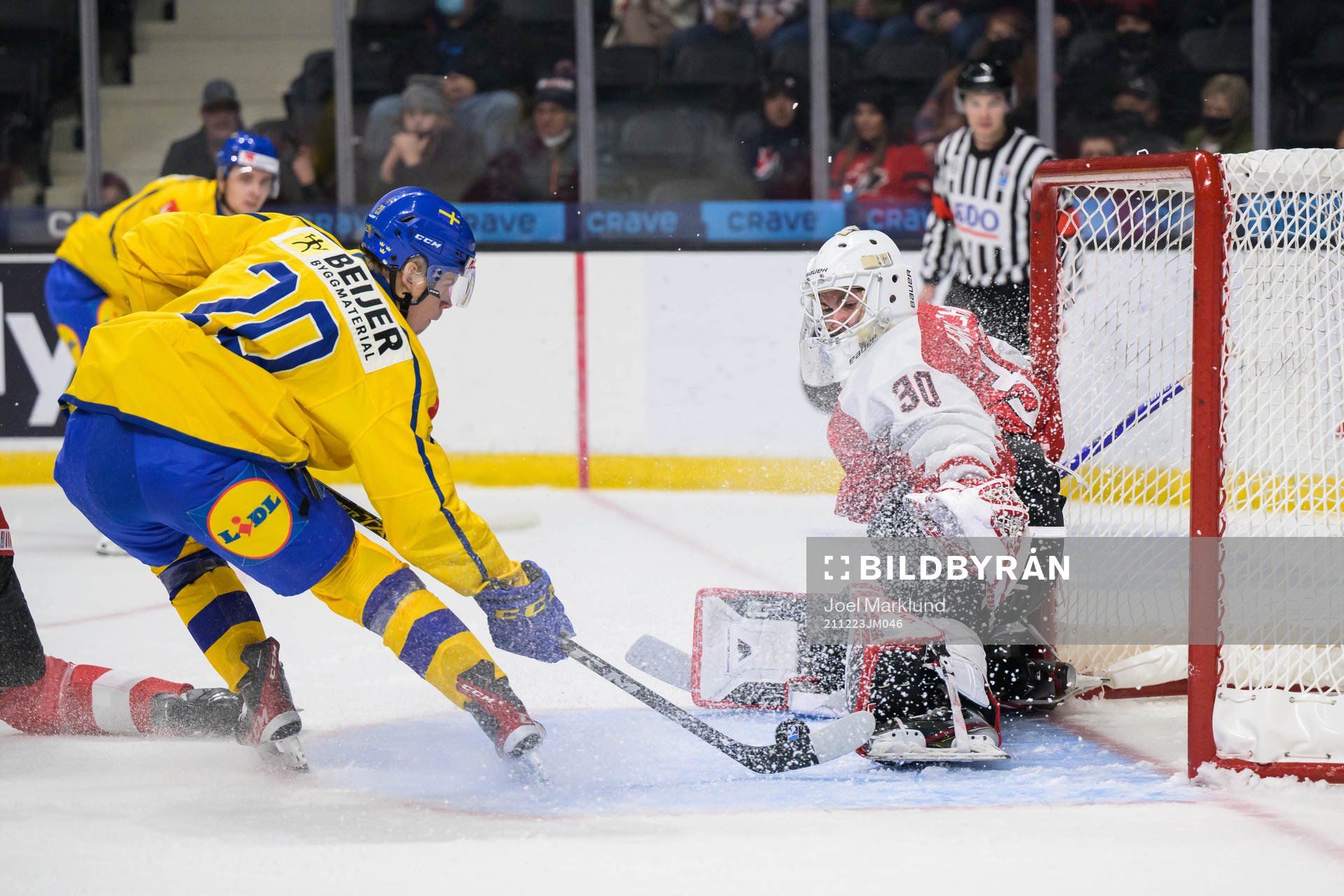 Albert Sjöberg of Sweden scores 2-0 behind goaltender