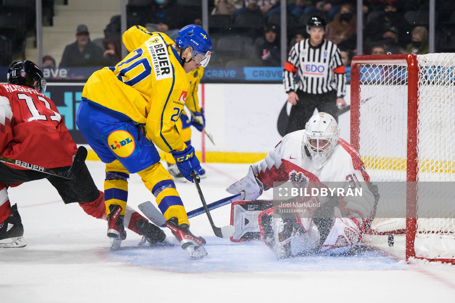 Albert Sjöberg of Sweden scores 2-0 behind goaltender