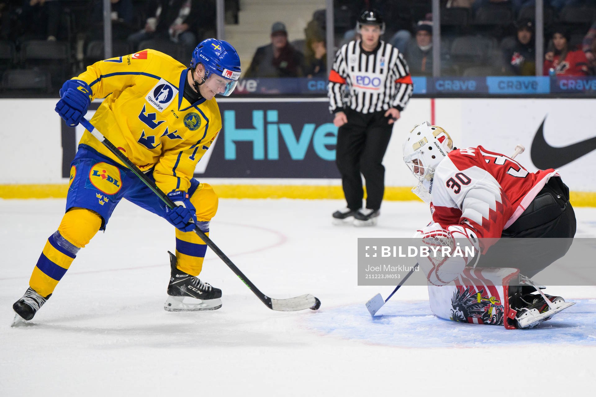 William Eklund of Sweden challenges goaltender Sebastian