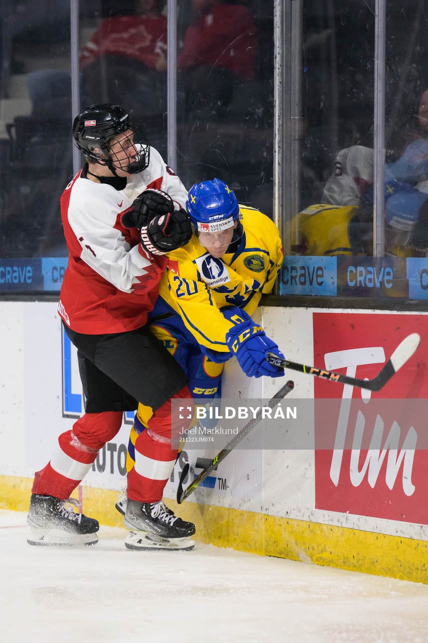 David Reinbacher of Austria tackles Albert Sjöberg of