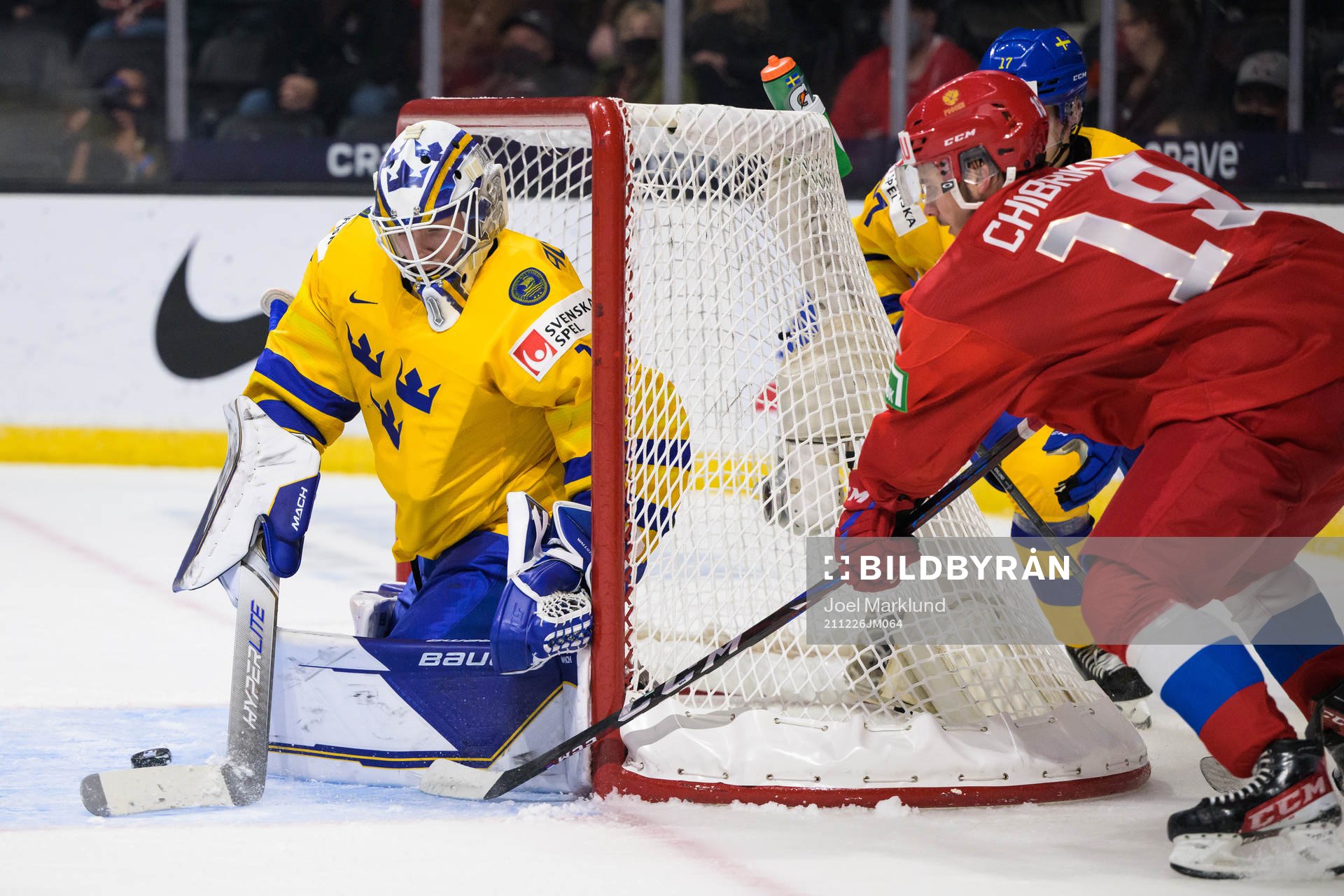 Goaltender Jesper Wallstedt of Sweden is being challenged