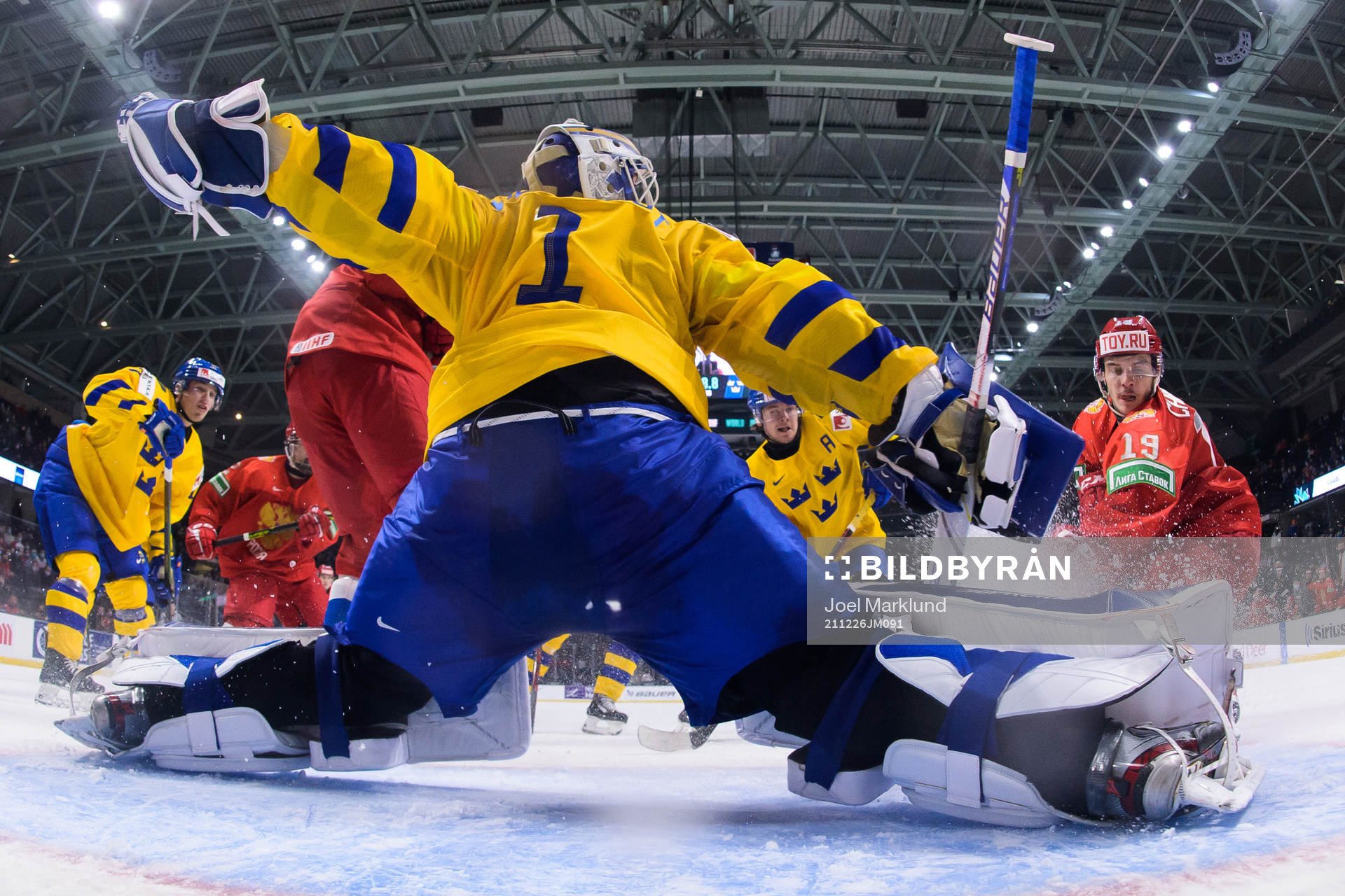 Goaltender Jesper Wallstedt of Sweden is being challenged