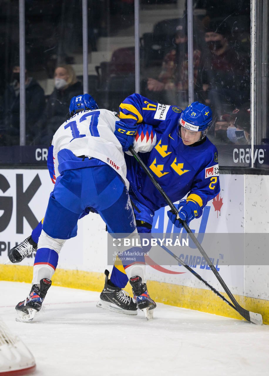 Simon Nemec of Slovakia tackles Elliot Ekmark of Sweden