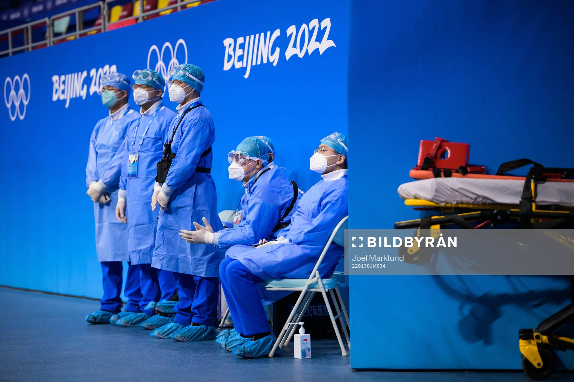 Medical personel in personal protective gear watch the