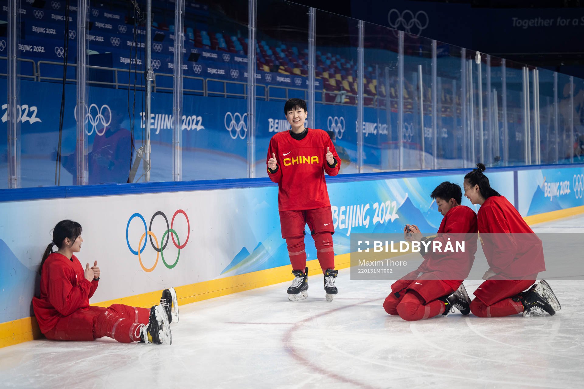 Players of China women’s ice hockey team take pictures of