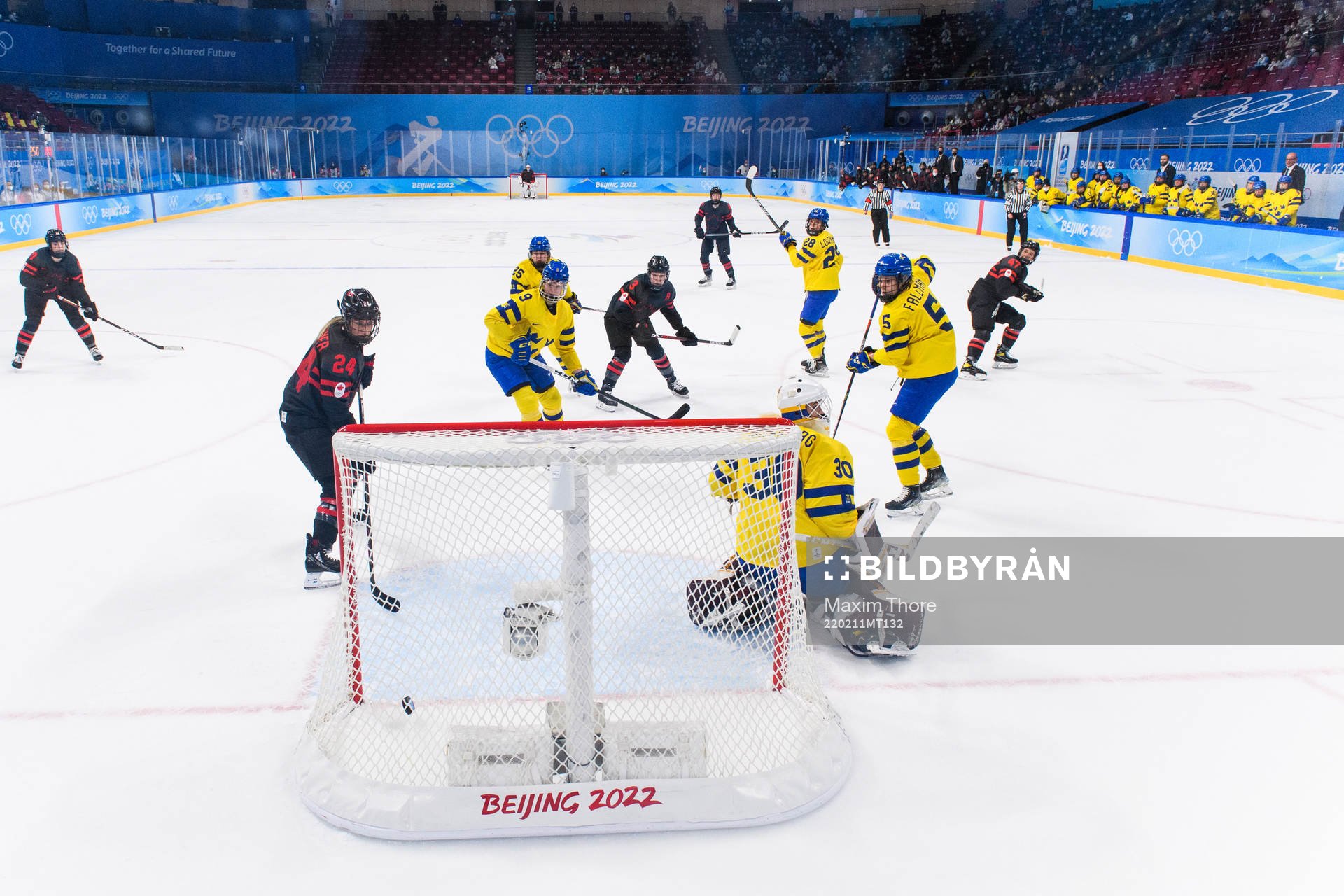 Natalie Spooner of Canada scores a goal behind goaltender