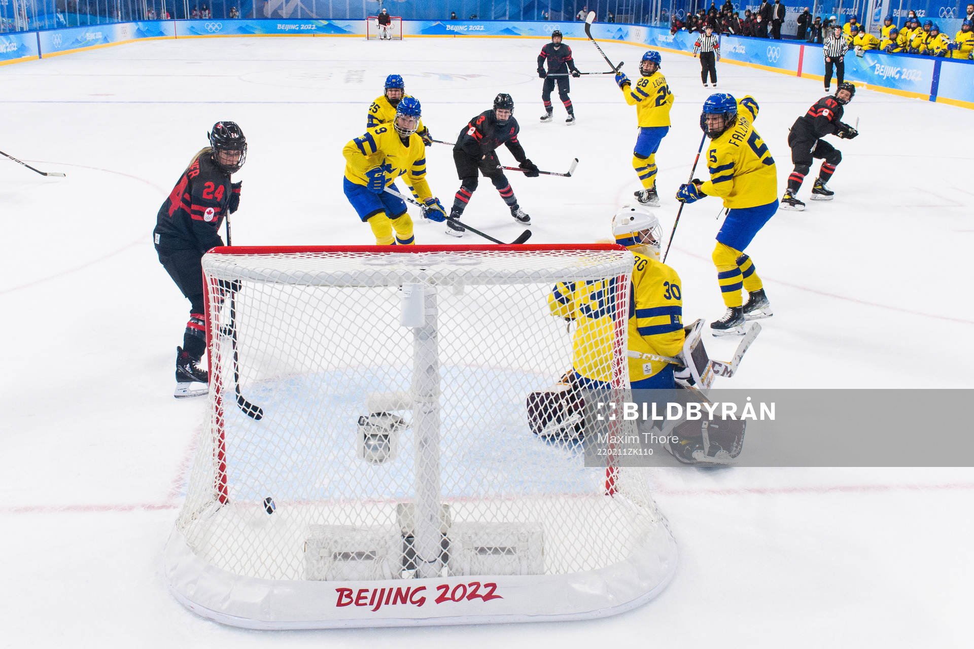 Natalie Spooner of Canada scores a goal behind goaltender