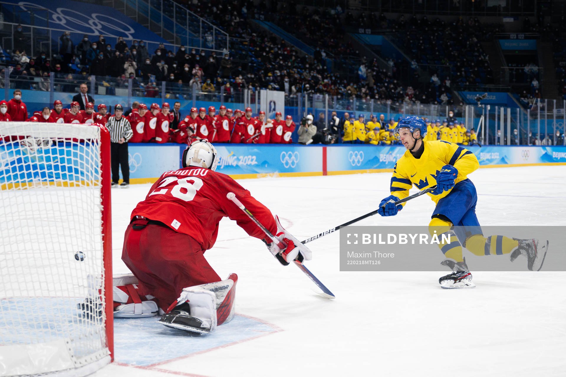 Goaltender Ivan Fedotov of Russia and Max Friberg of Sweden