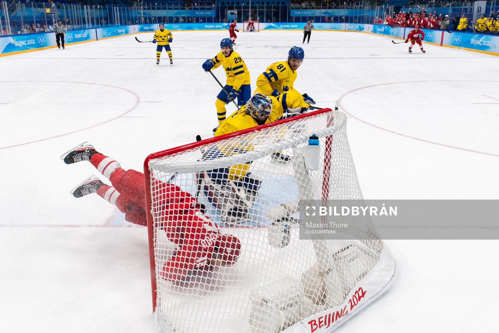 Pavel Karnaukhov of Russia in a collision with goaltender