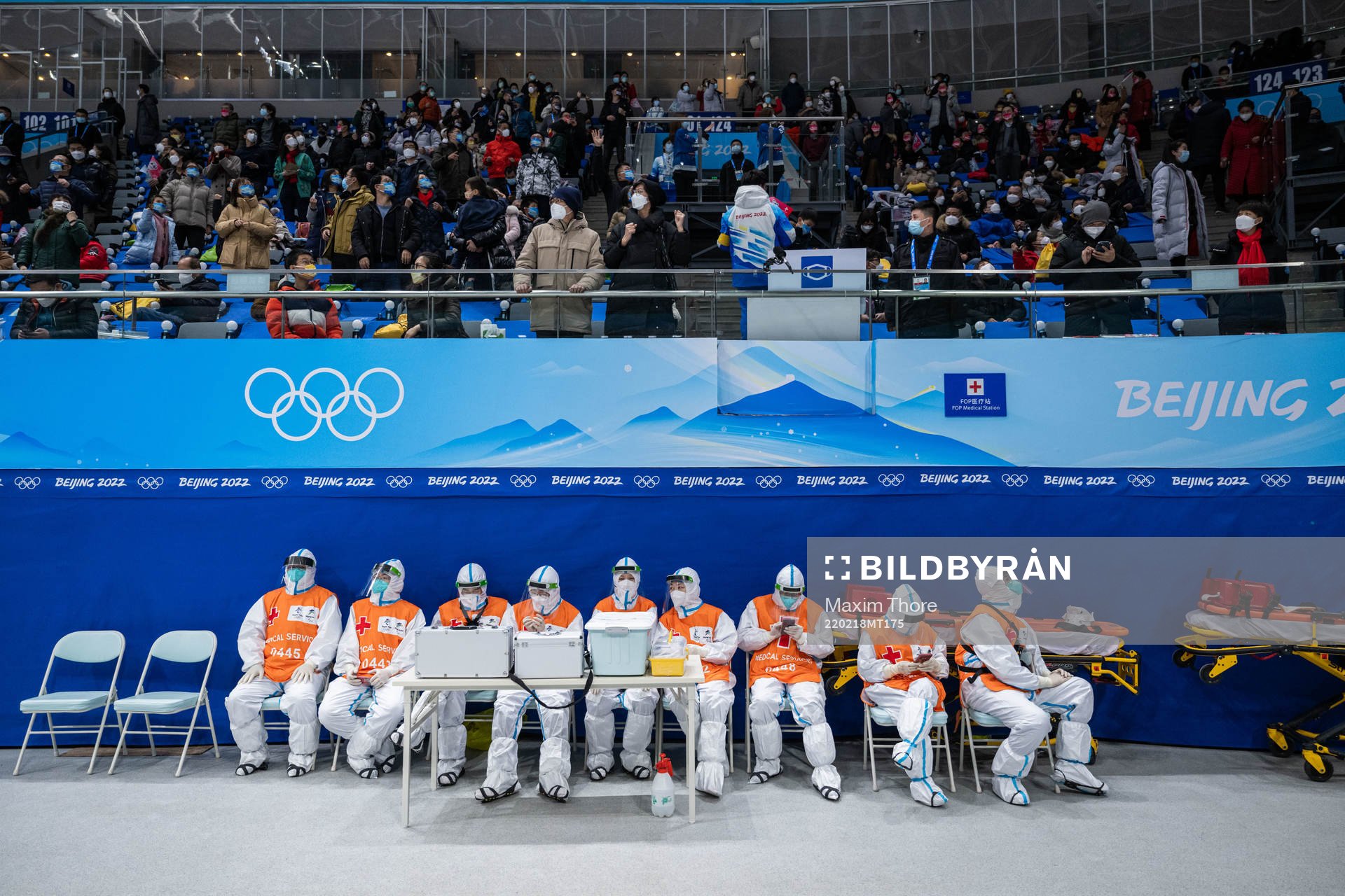 Spectators and medical personel in full protective