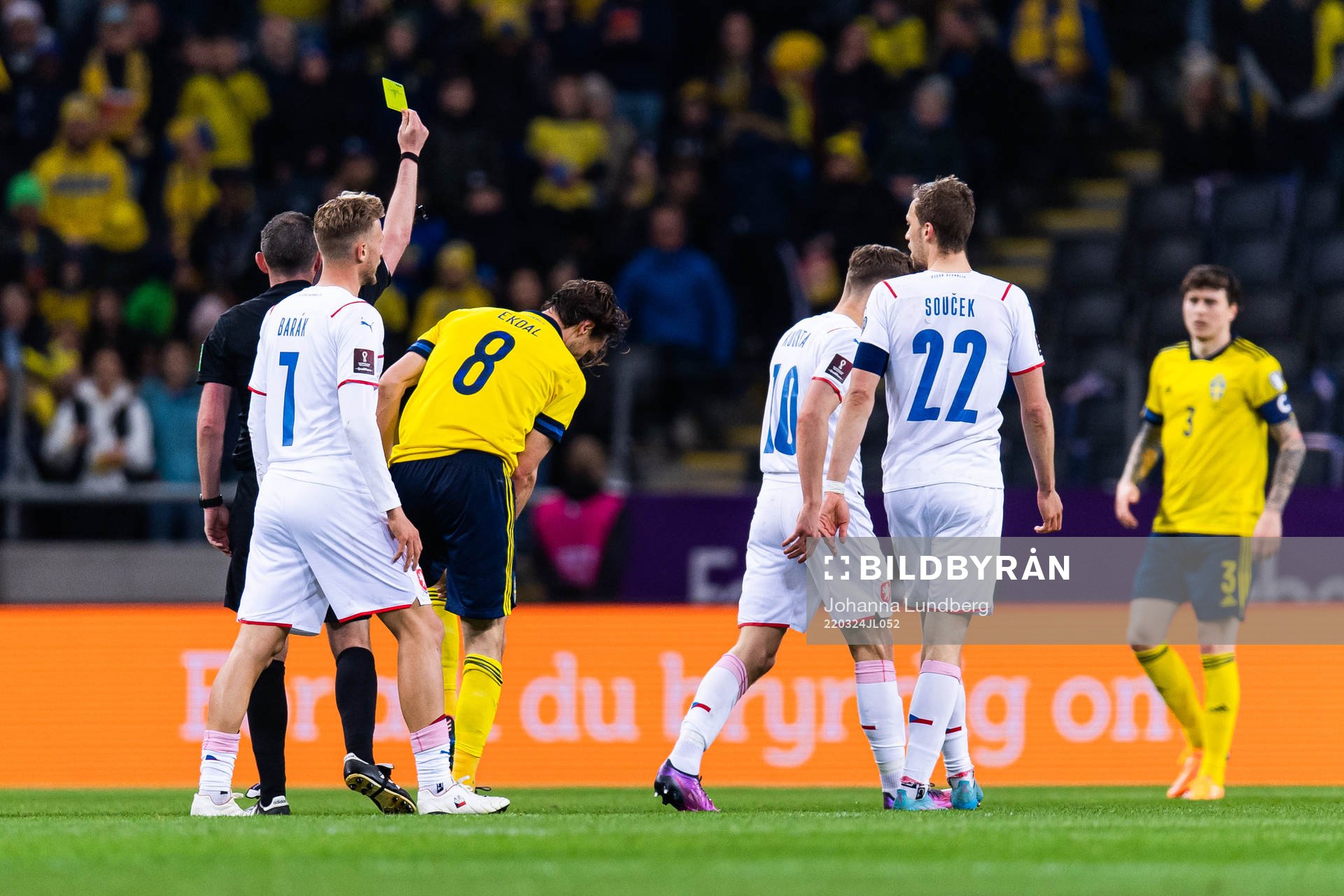 Albin Ekdal of Sweden receives a yellow card from referee