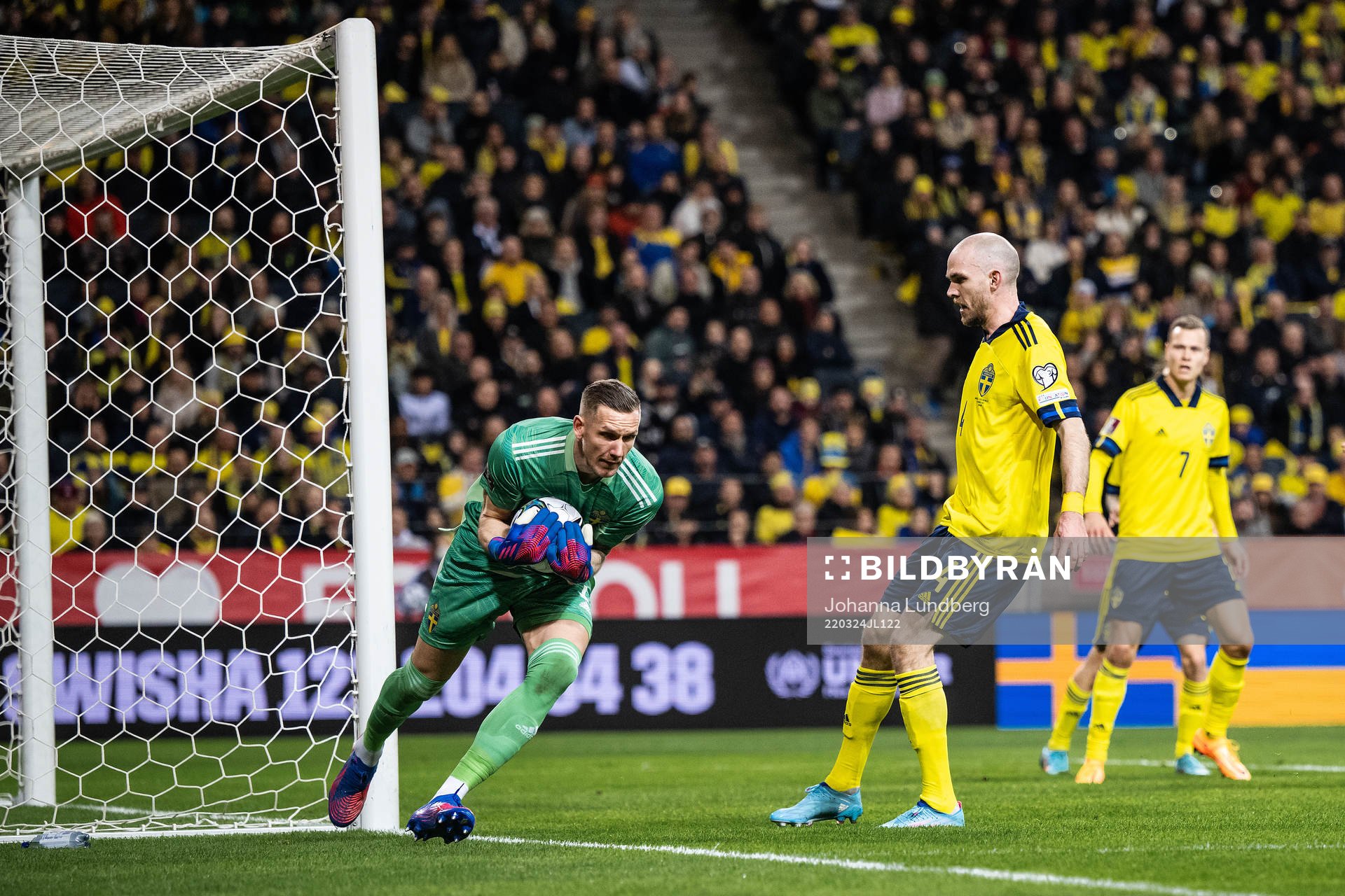 goalkeeper Robin Olsen and Marcus Danielson of Sweden