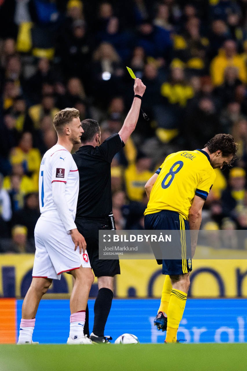 Albin Ekdal of Sweden receives a yellow card from referee
