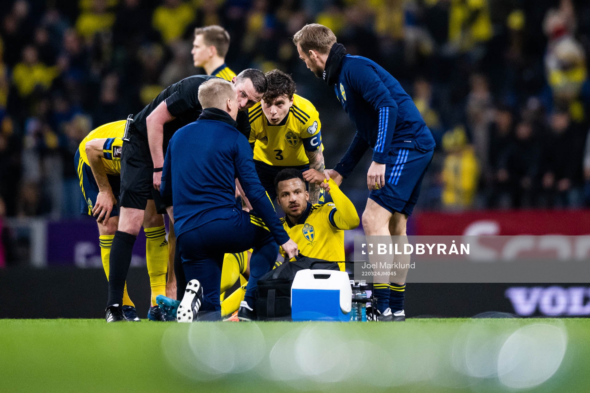 Martin Olsson of Sweden receives medical attention