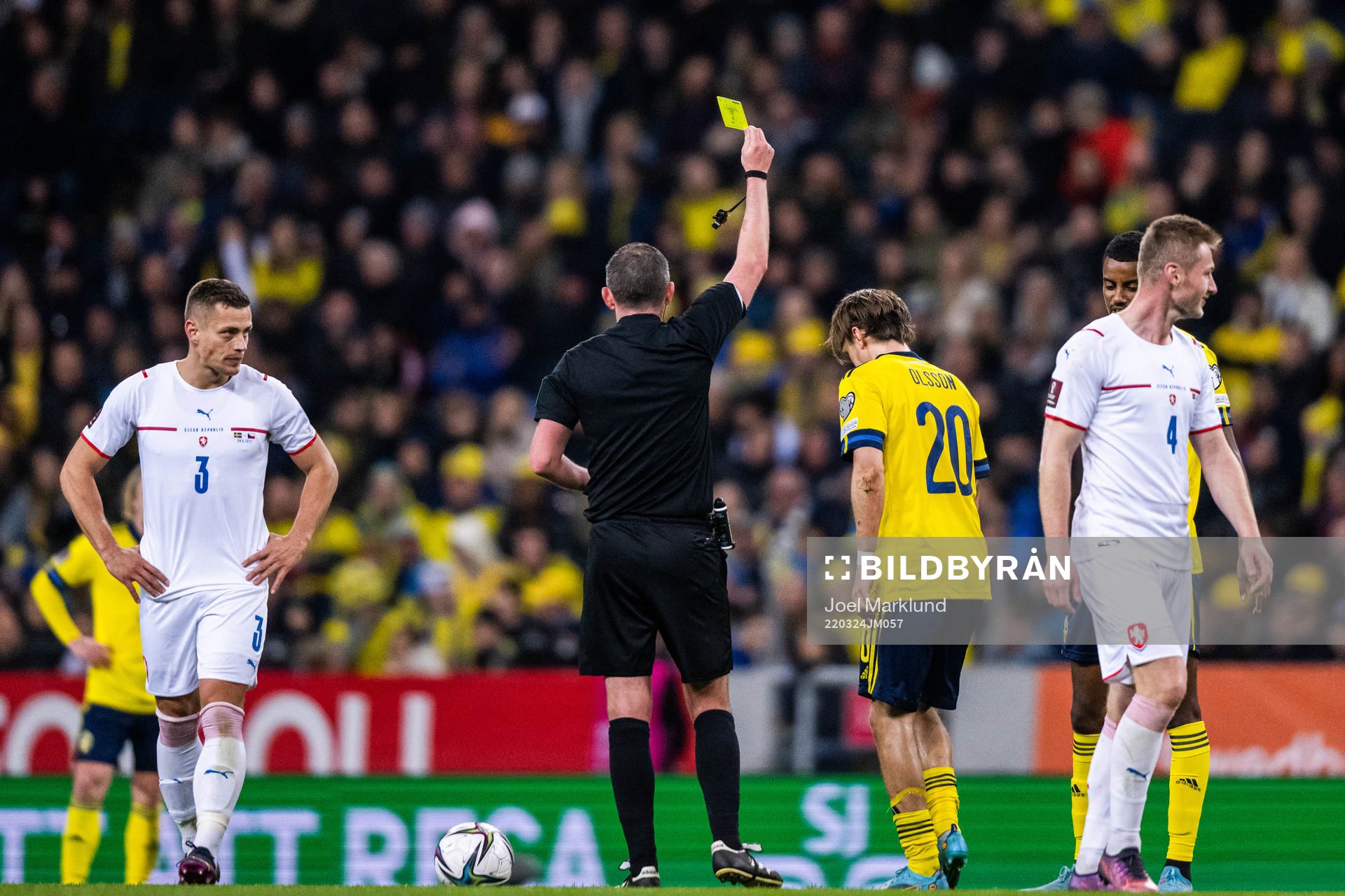 Kristoffer Olsson of Sweden receives a yellow card from
