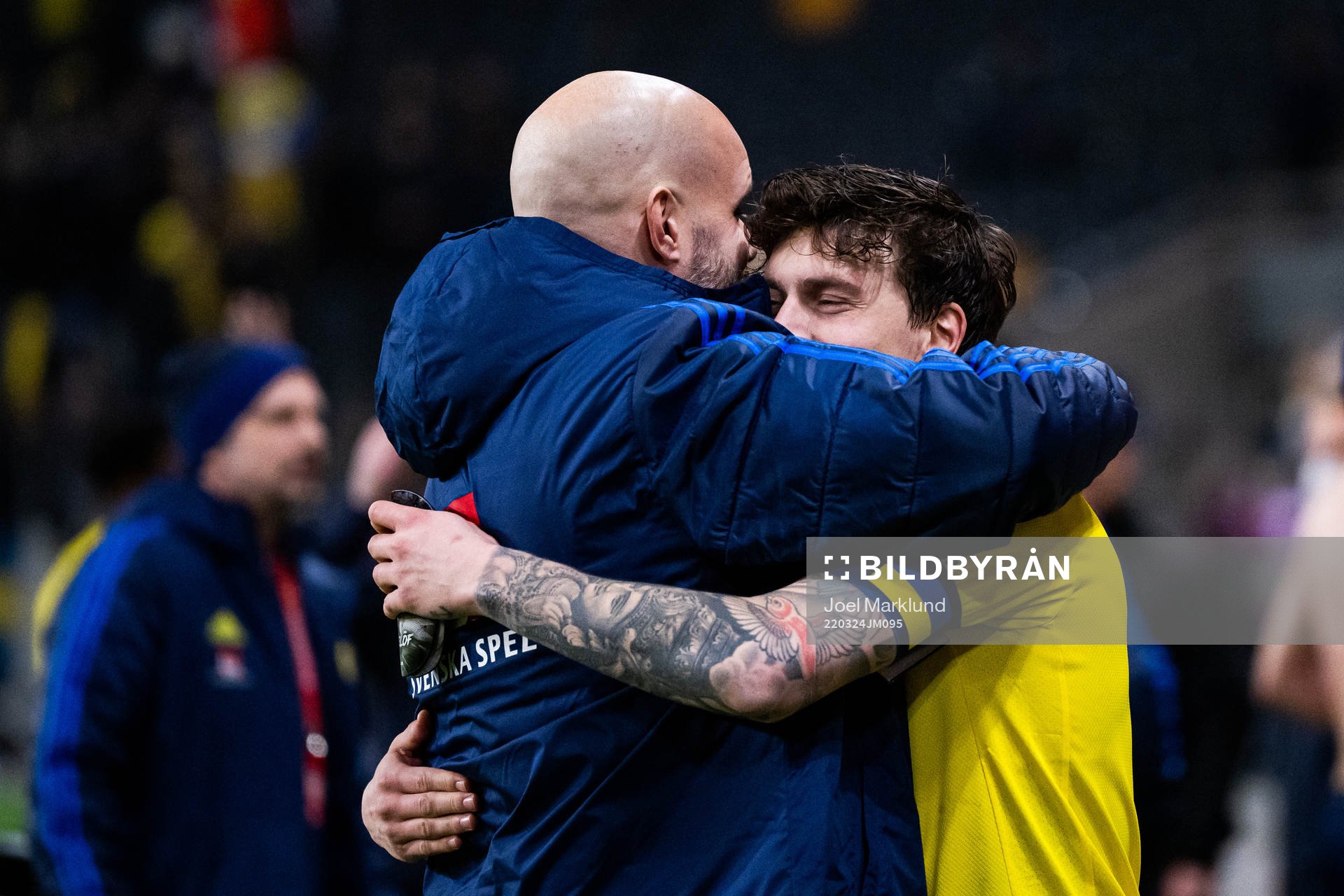 Press officer Jakob Kakembo Andersson hugs Victor Lindelöf of Sweden after the FIFA World Cup Qualifier play-off semifinal between Sweden and Czech Republic on March 24, 2022 in Stockholm.