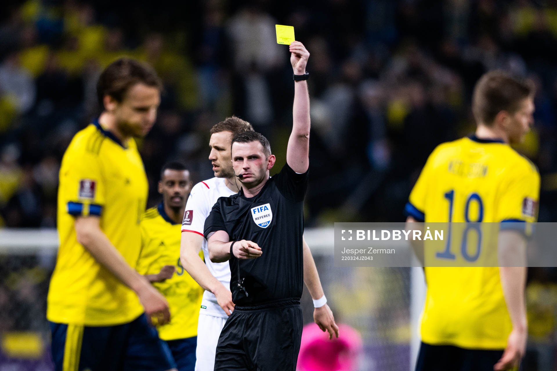 Joakim Nilsson of Sweden receives a yellow card from