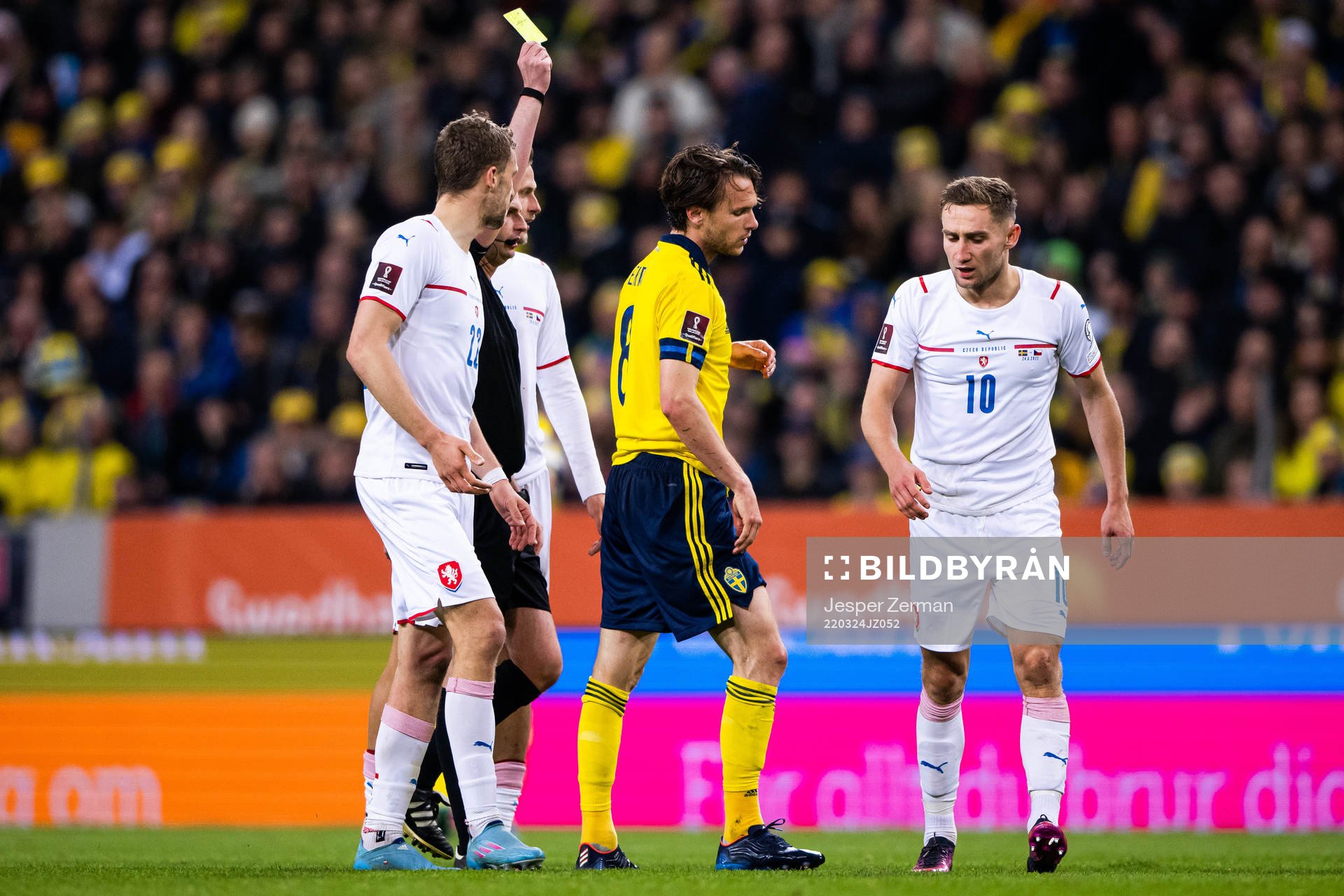 Albin Ekdal of Sweden receives a yellow card from referee