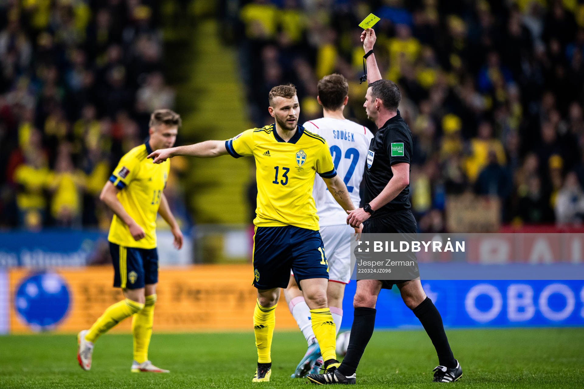 Jesper Karlström of Sweden receives a yellow card from