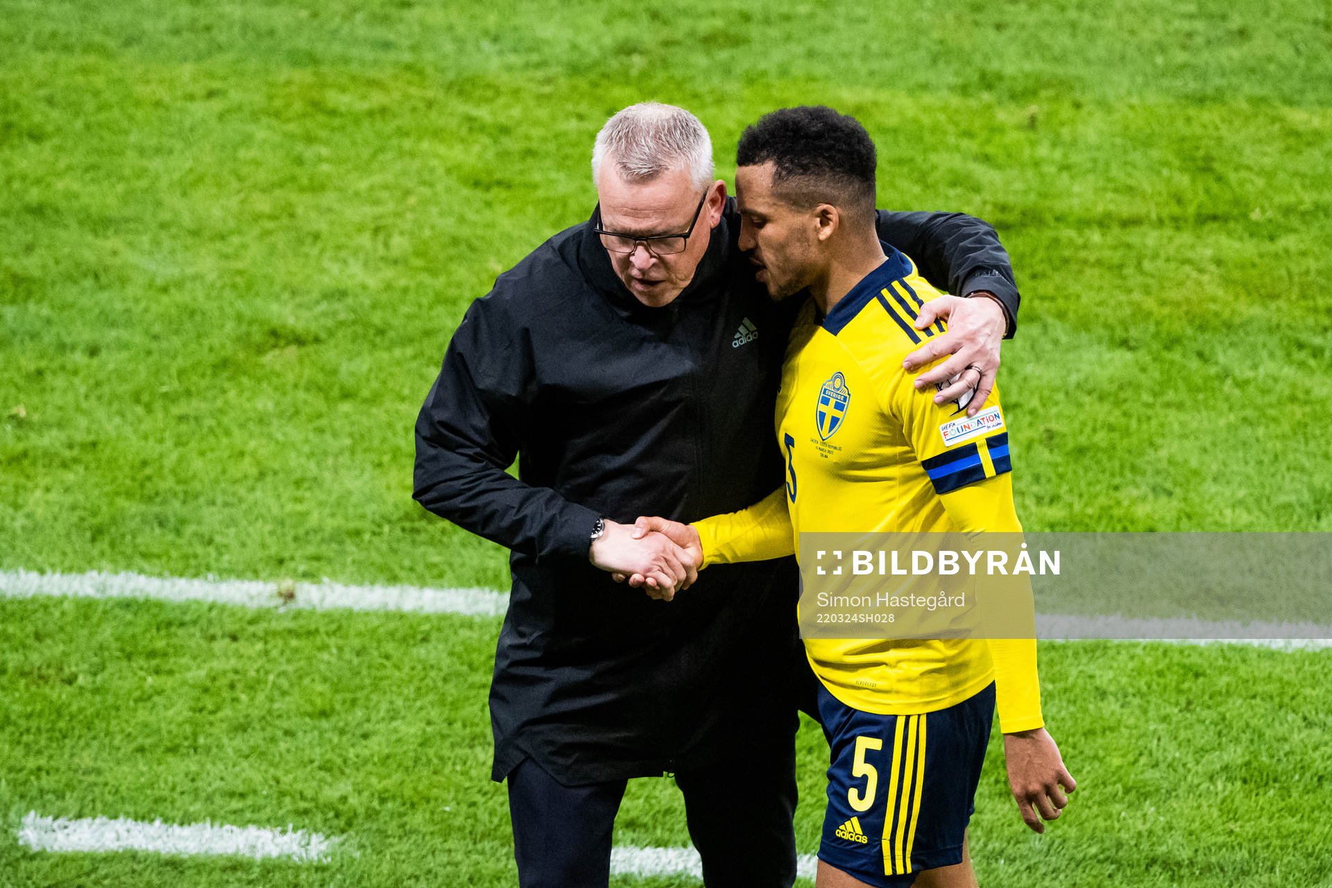 head coach Janne Andersson greets Martin Olsson of Sweden