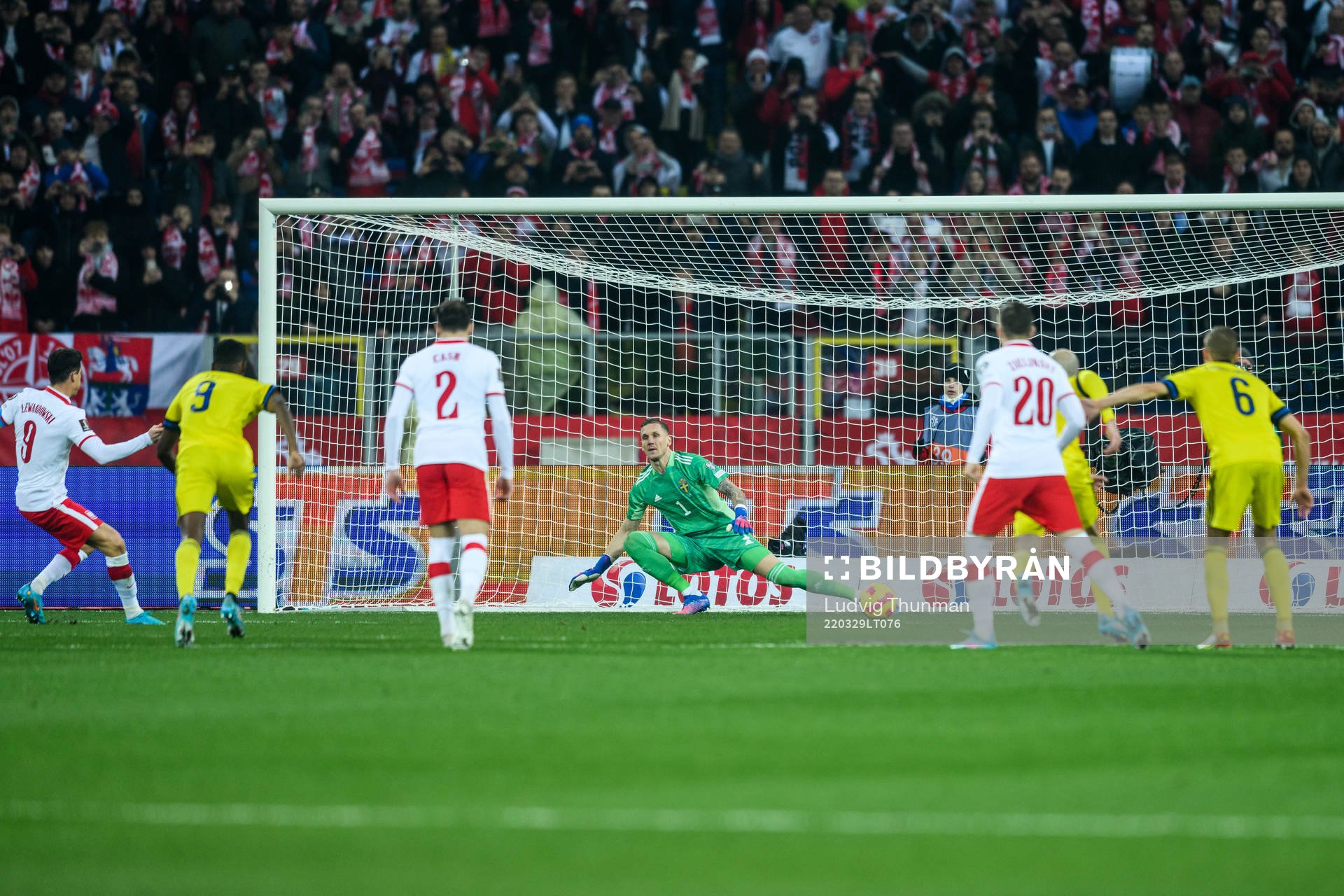 Robert Lewandowski of Poland scores 1-0 against goalkeeper