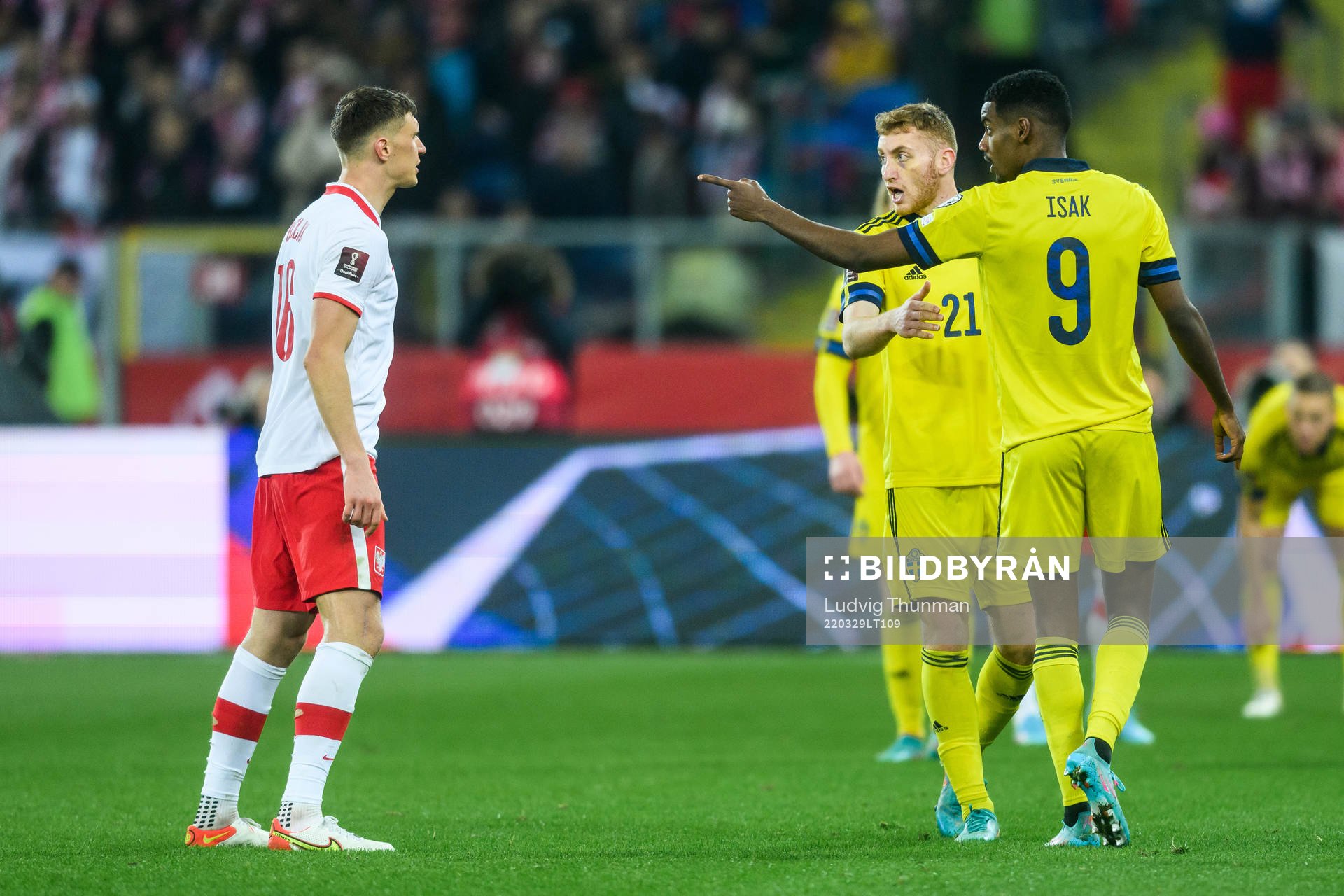 Krystian Bielik of Poland and Alexander Isak of Sweden