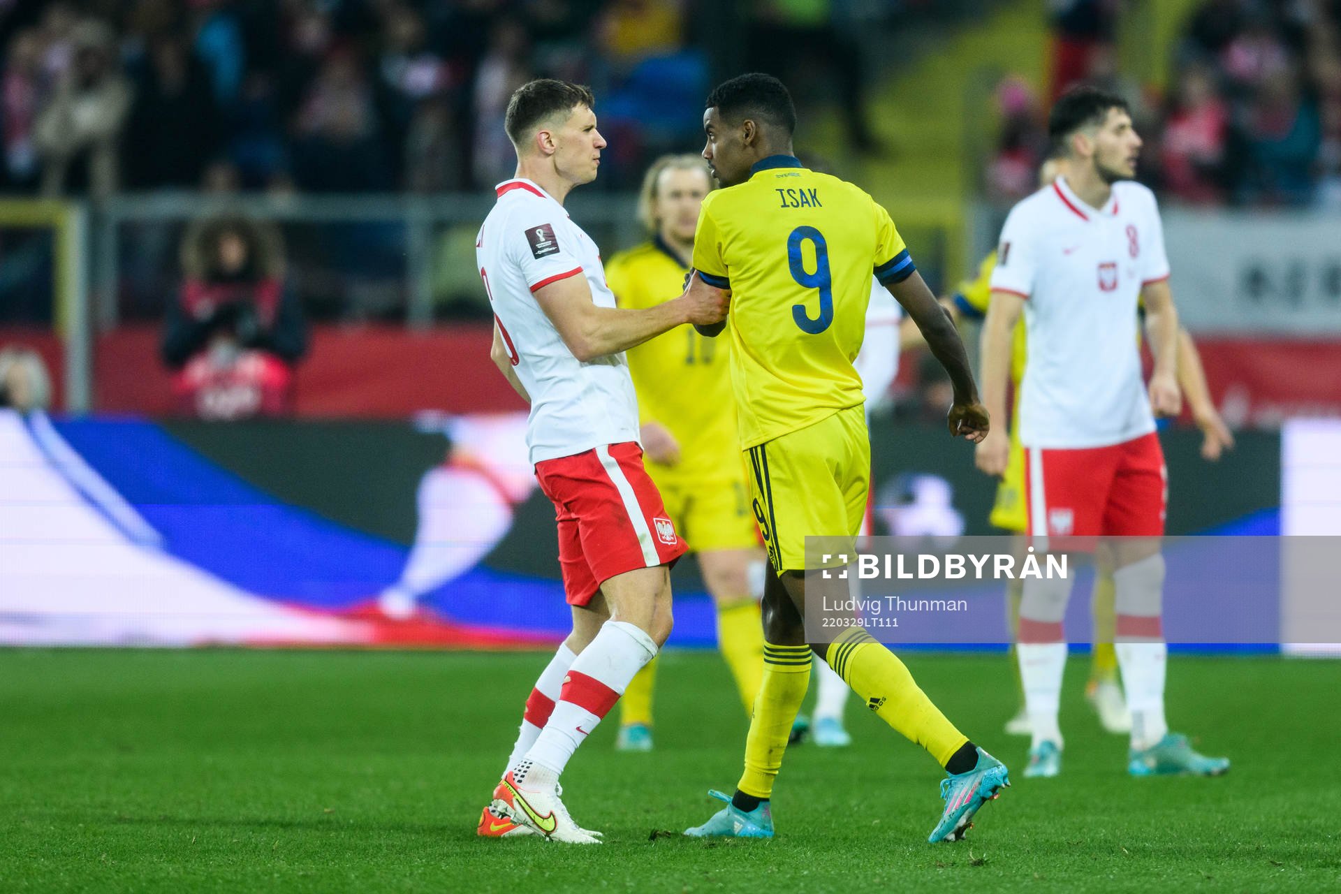 Krystian Bielik of Poland and Alexander Isak of Sweden
