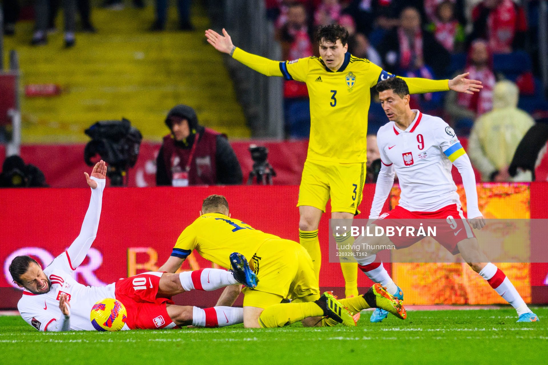 Piotr Zielinski of Poland falls in a duel with Jesper