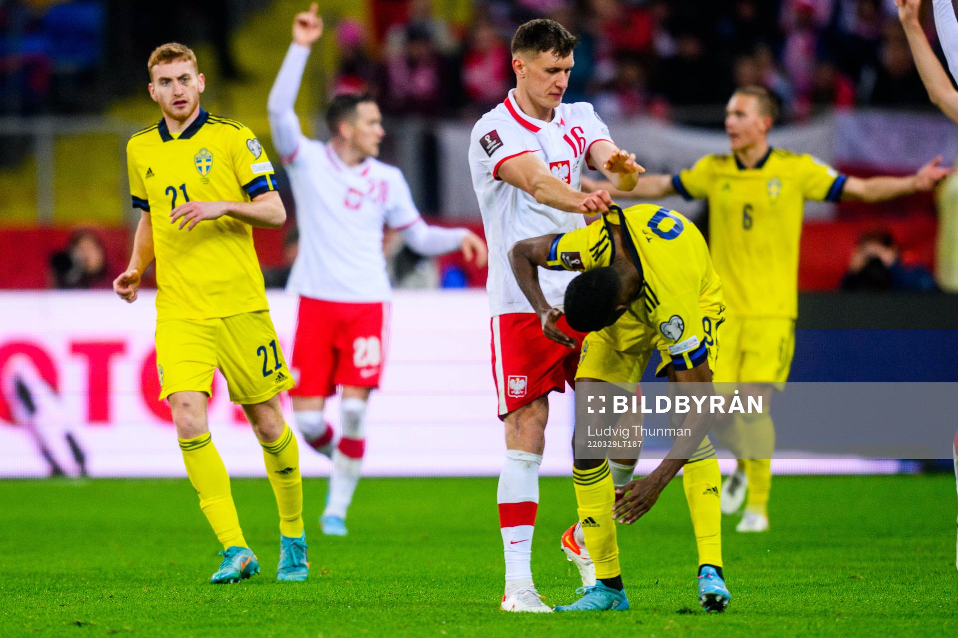 Krystian Bielik of Poland and Alexander Isak of Sweden