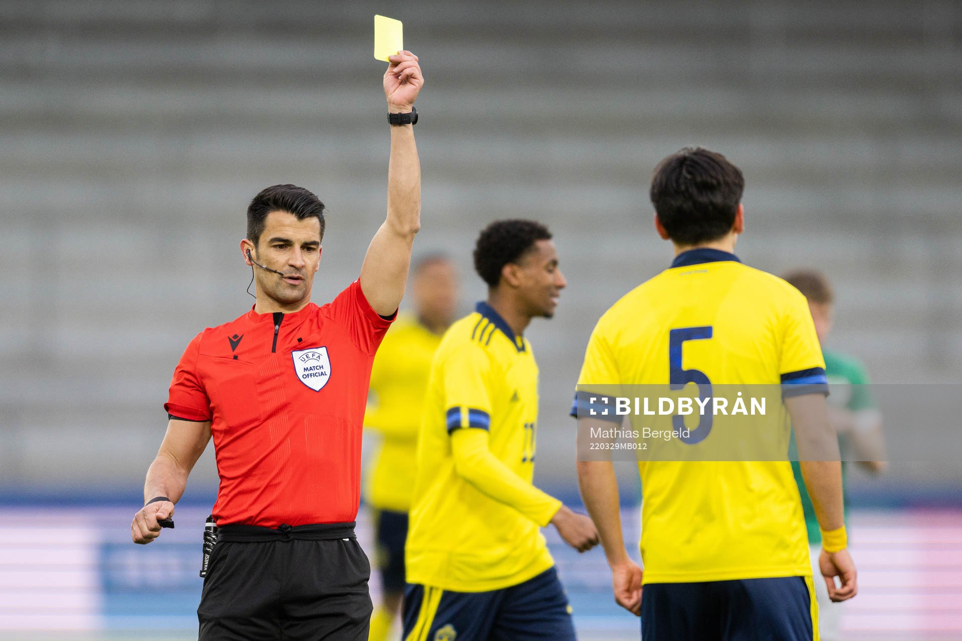 Eric Kahl of Sweden receives a yellow card from referee