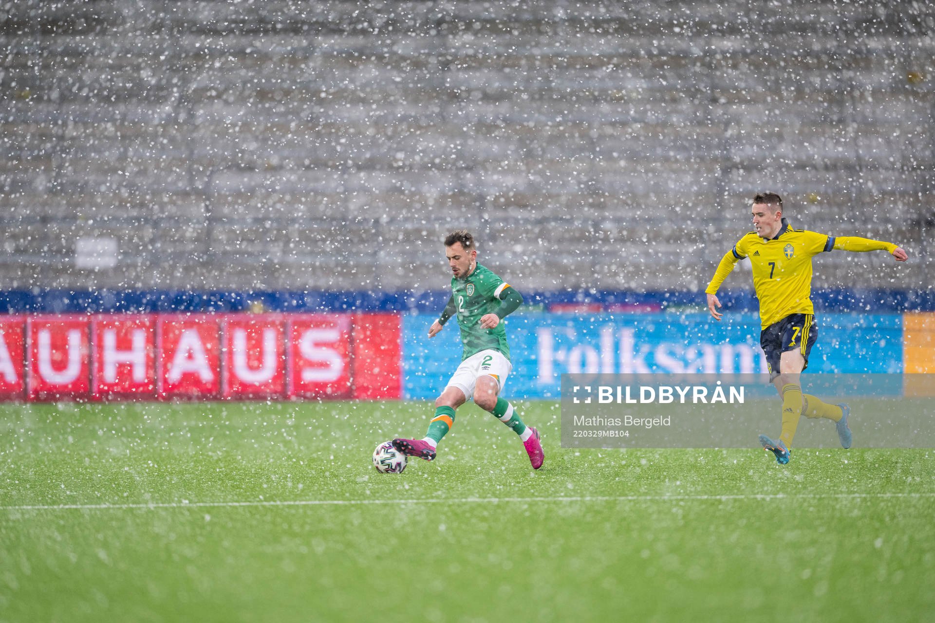 Lee O'Connor of Ireland and Patrik Wålemark of Sweden in snowfall during the UEFA European Under-21 Qualifier football match between Sweden and Ireland on March 29, 2022 in Borås.
