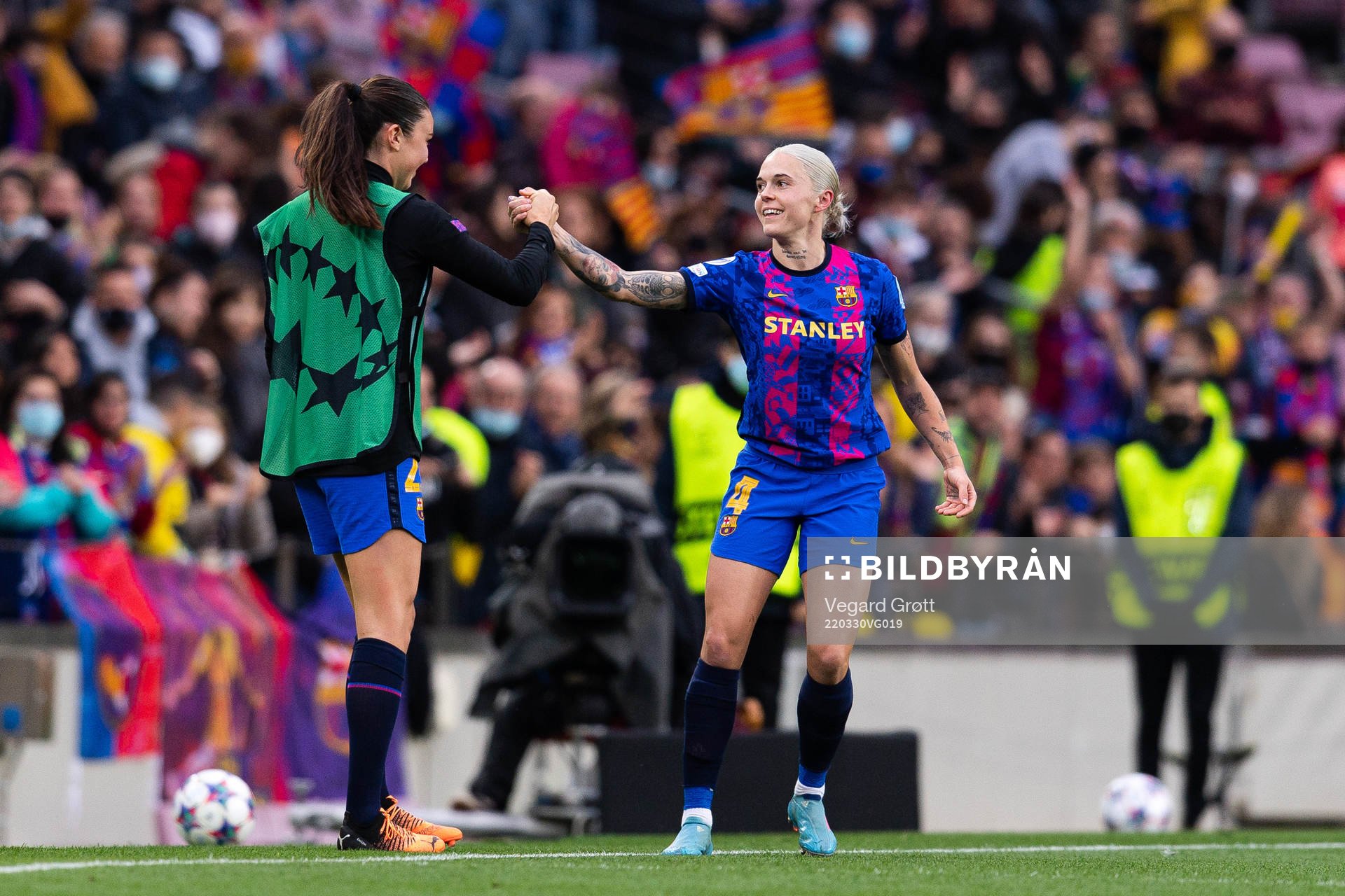 Ingrid Syrstad Engen and Mapi Leon of Barcelona celebrate the 1-0 goal during the UEFA Women's Champions League football match between Barcelona and Real Madrid on March 30, 2022 in Barcelona.