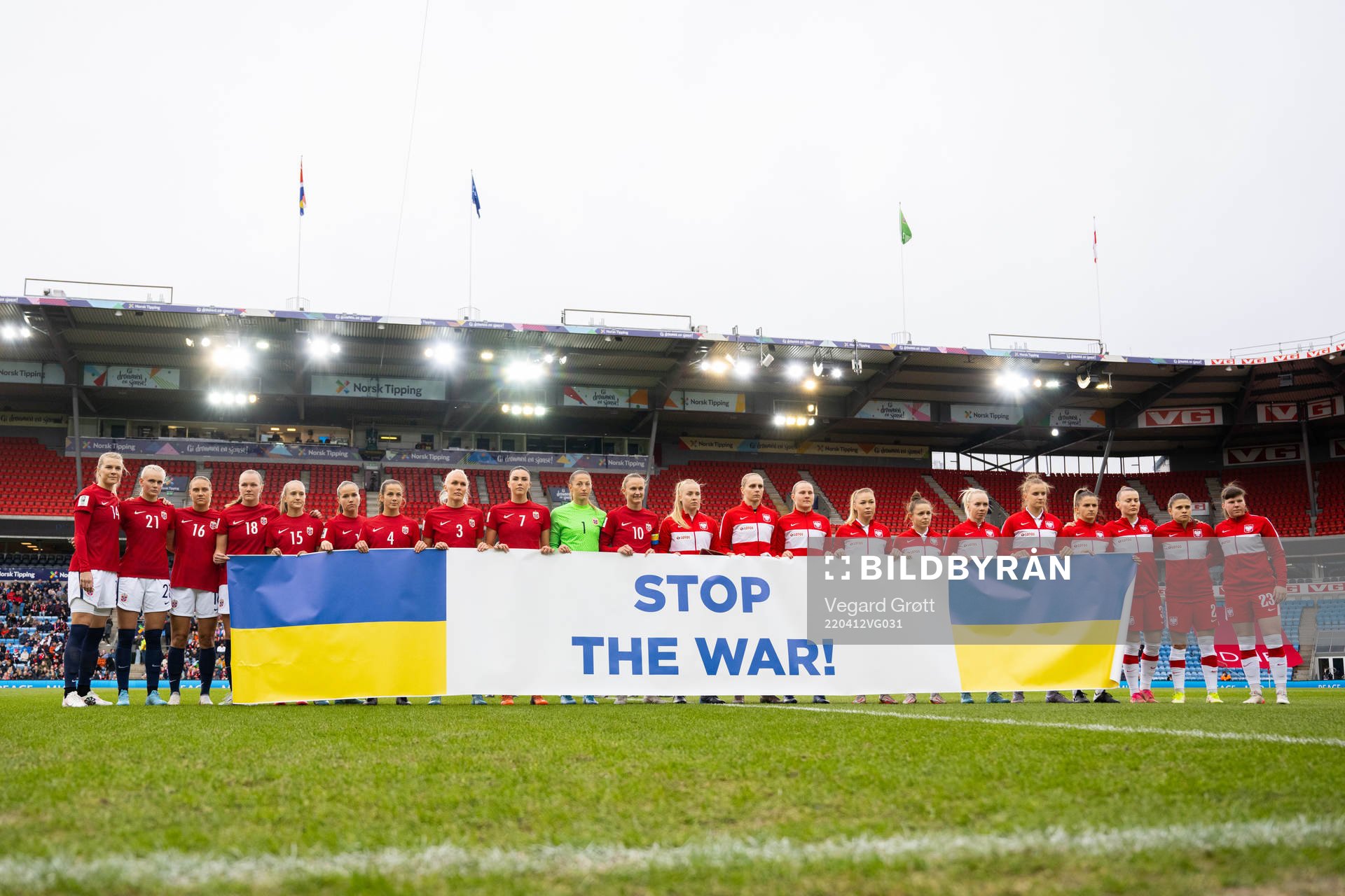 Players of Norway and Poland with a Stop the War! banner