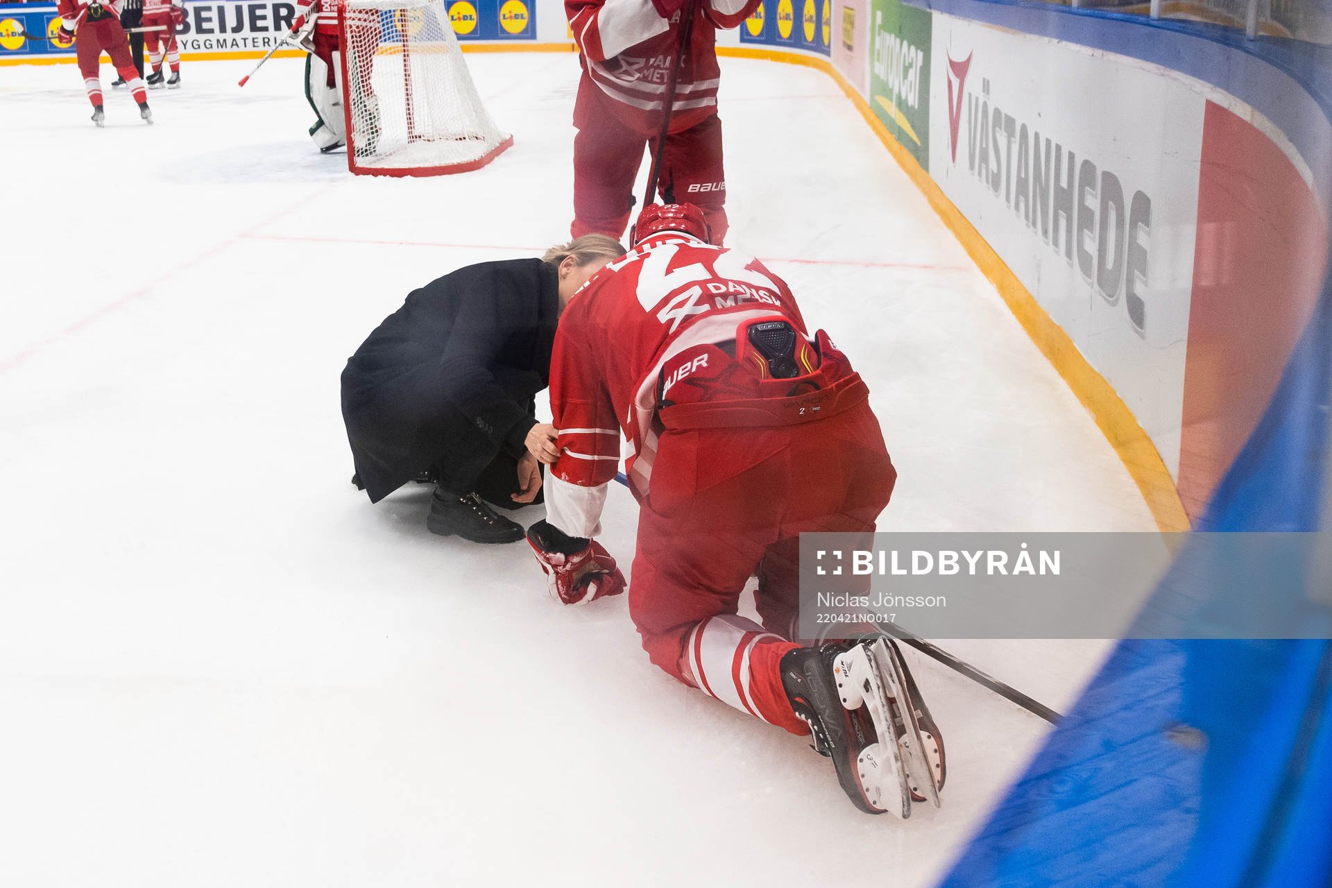 Markus Lauridsen of Denmark receives medical attention
