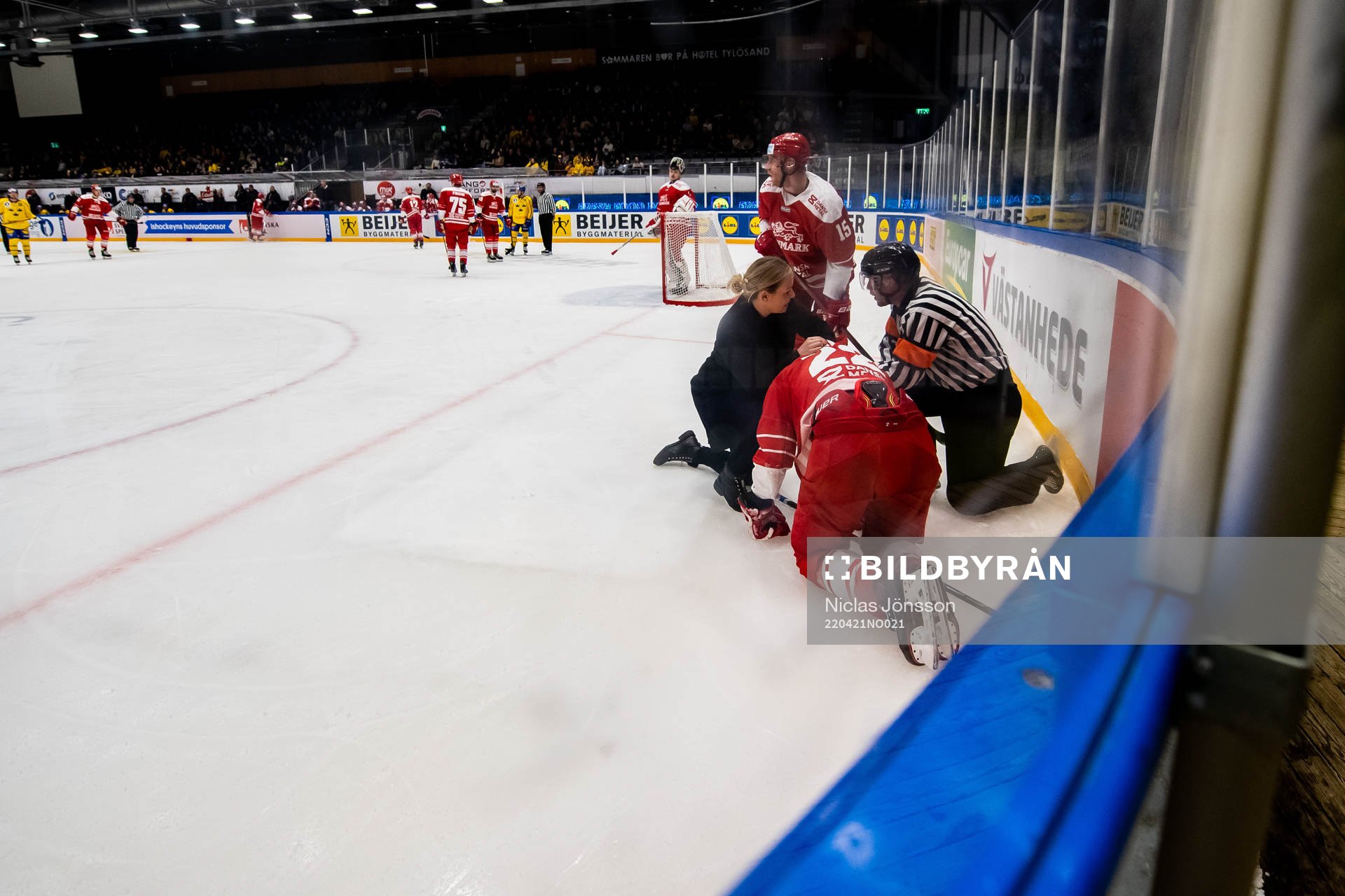 Markus Lauridsen of Denmark receives medical attention