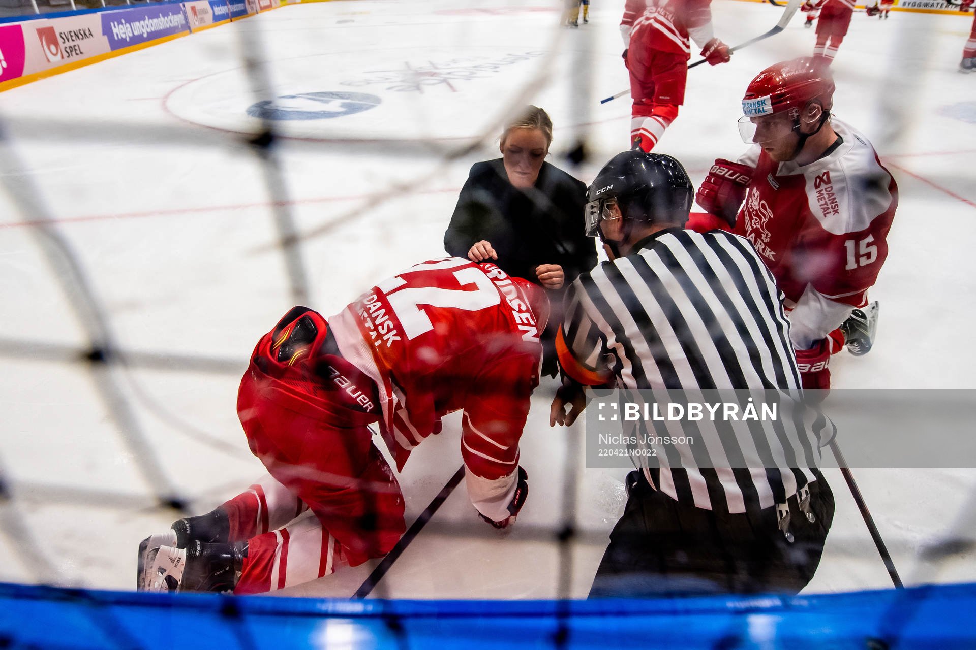 Markus Lauridsen of Denmark receives medical attention