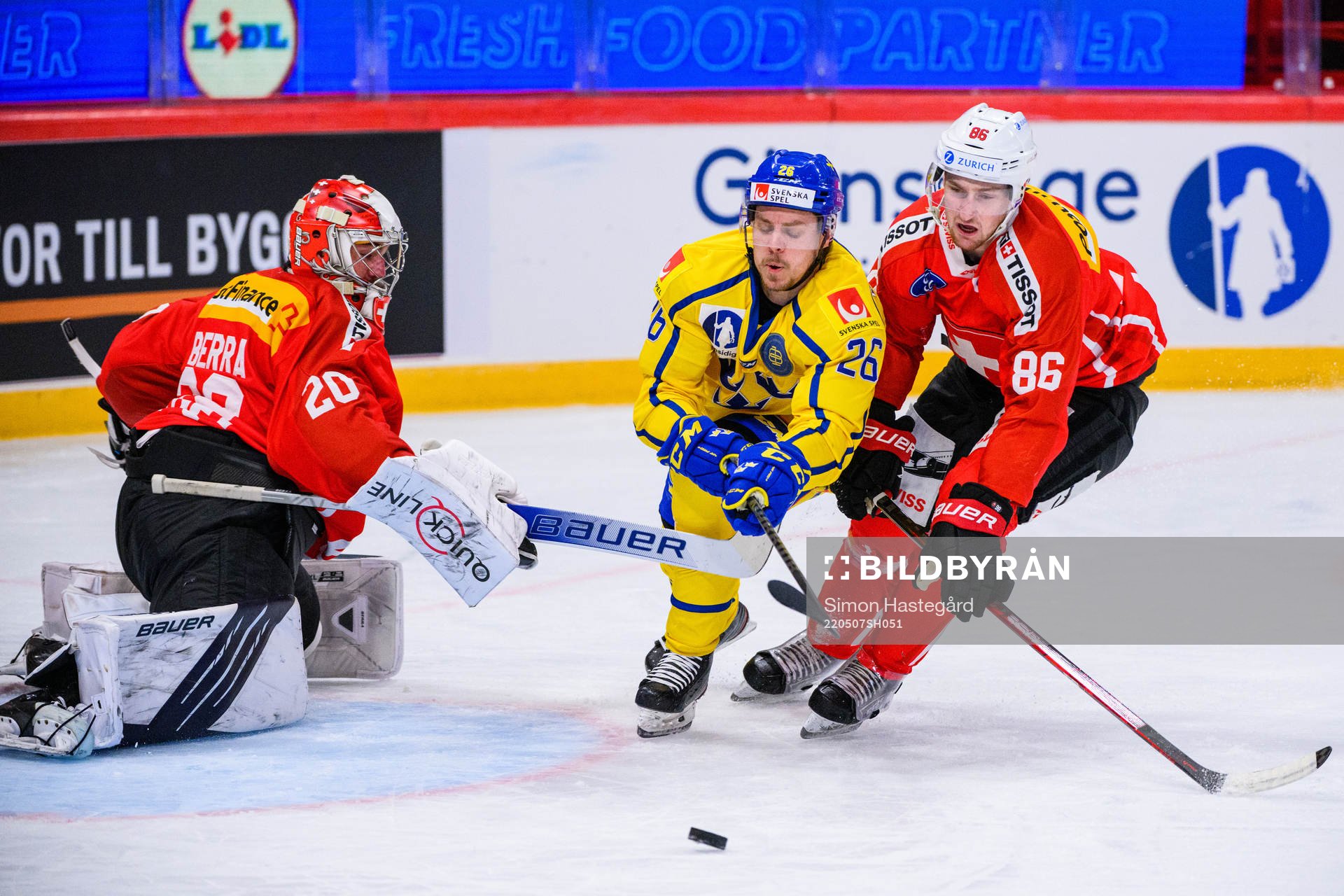 Joel Kellman of Sweden with Goalkeeper Reto Berra and Janis