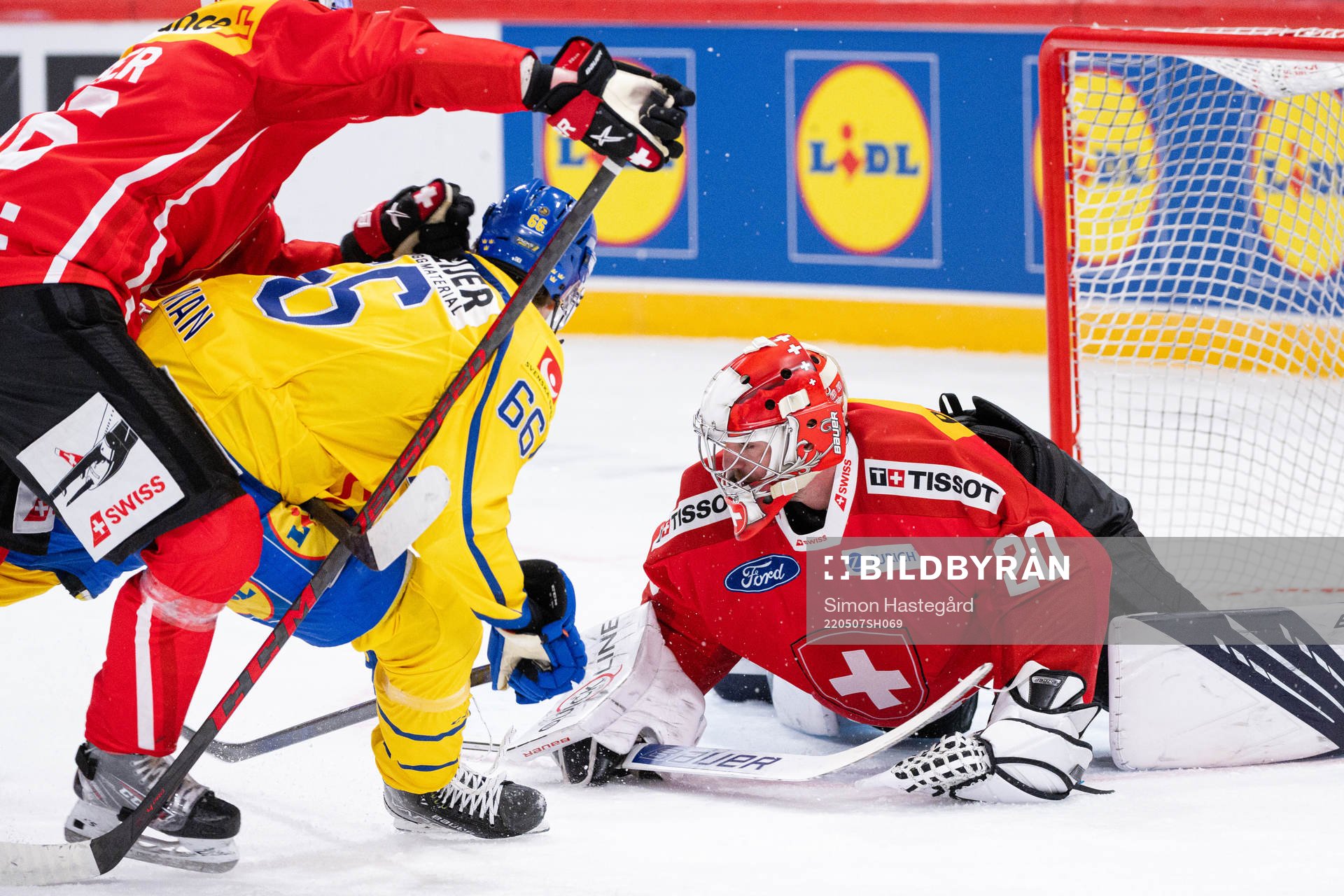 Nils Åman of Sweden against Goalkeeper Reto Berra of