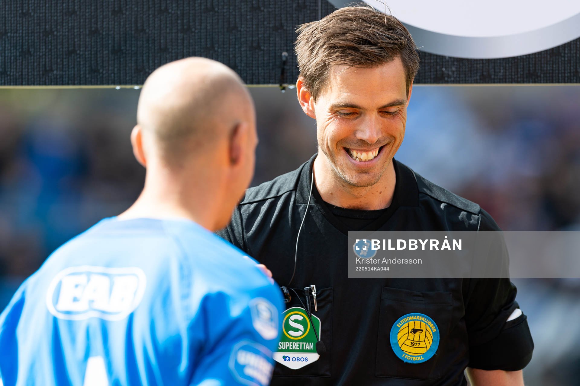 Domare Magnus Lindgren singlar slant före fotbollsmatchen
