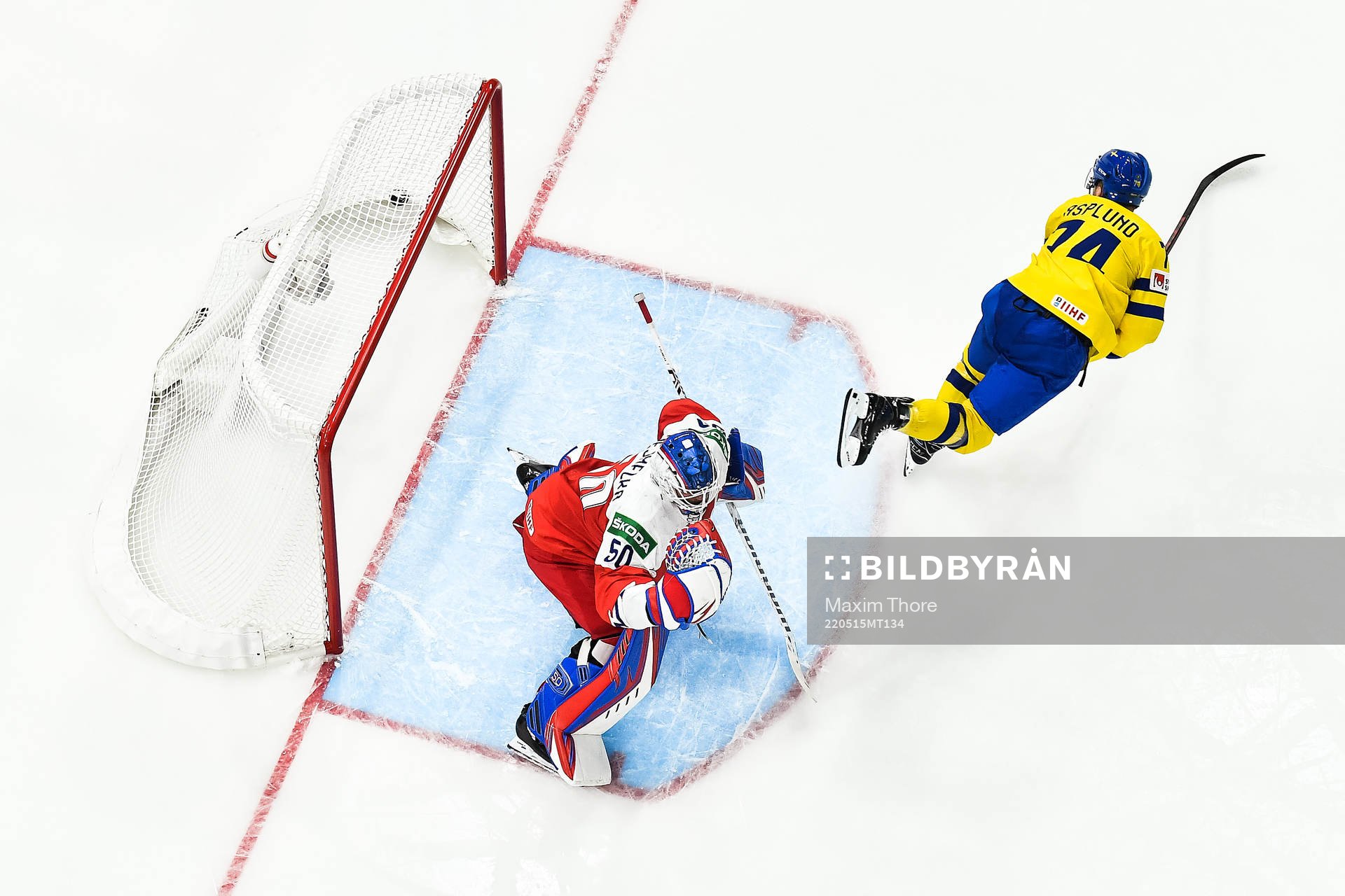 Rasmus Asplund of Sweden scores 1-4 behind goaltender Karel