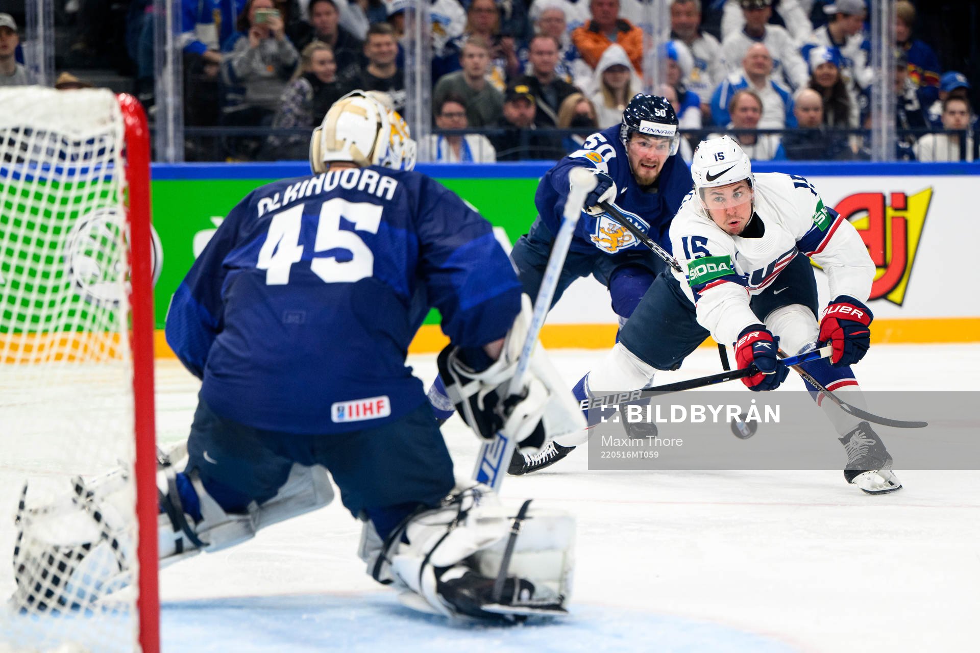John Hayden of USA against goaltender Juho Olkinuora of