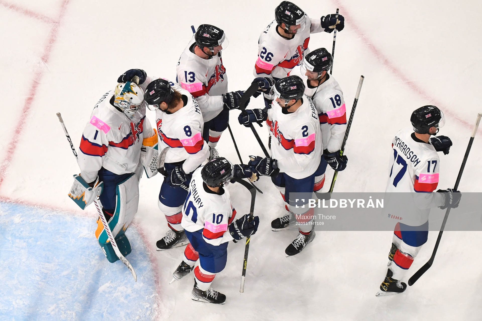 Goaltender Jackson Whistle of Great Britain with teammates